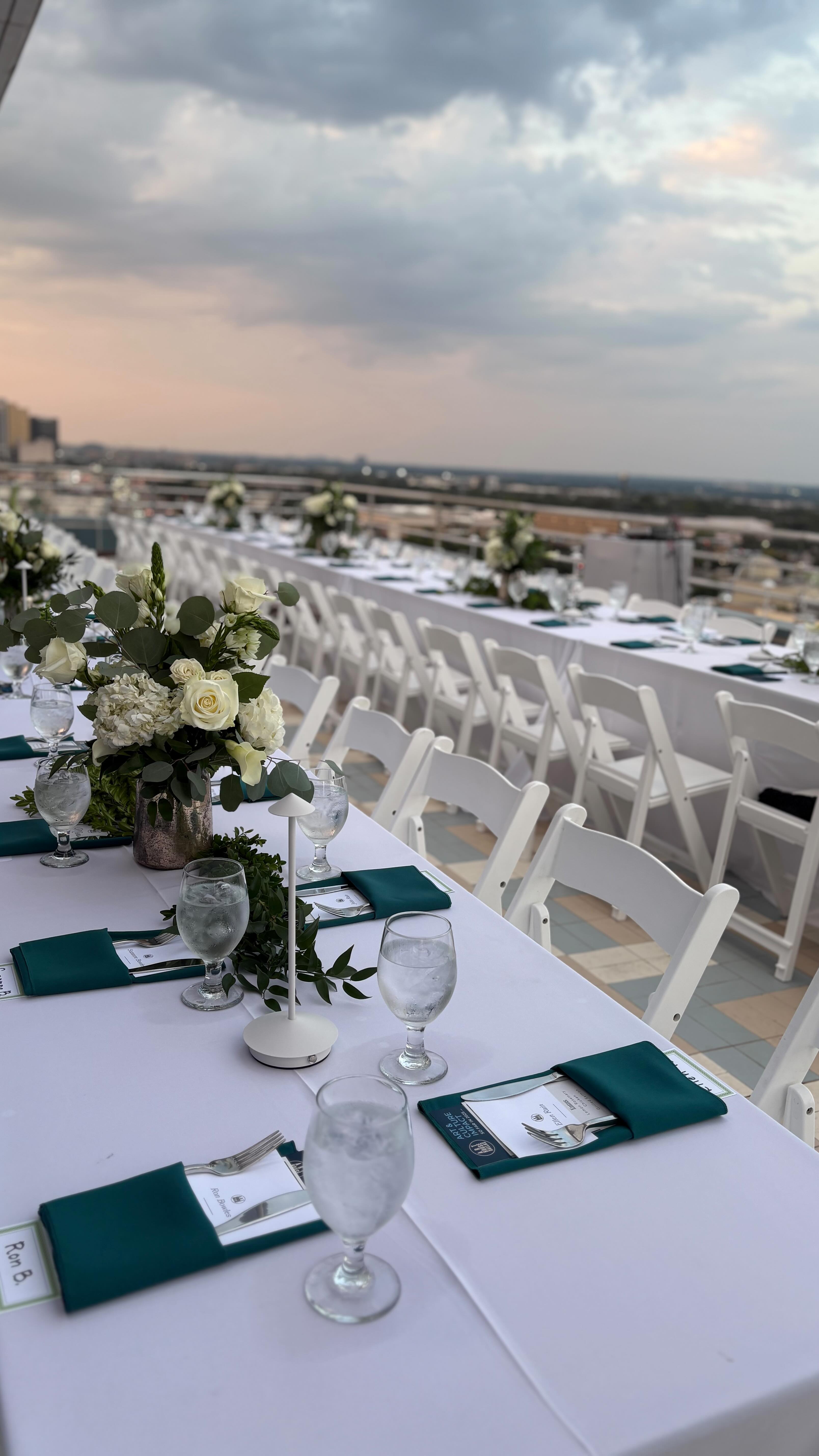 Table settings on a rooftop overlooking Dallas at sunset. Perfect setting for a fundraiser dinner for @arthousedallas
#dallascatering #catering