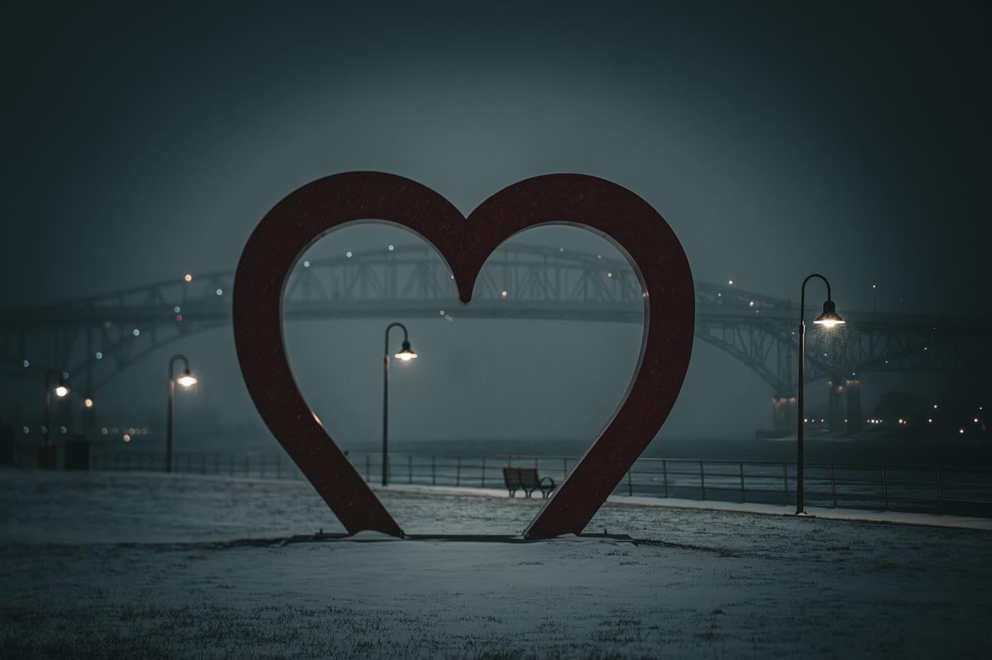 Winter nights by the waterfront bring out the beauty in every moment. Captured this stunning heart sculpture framing the iconic bridge under a blanket of soft snow. Let the quiet lights and gentle snowfall remind you that love shines even on the coldest nights. ❄️❤️✨
#WinterNights #LoveInTheAir #HeartSculpture #BridgeView #SnowfallMagic #RomanticDestinations #CityLights #WaterfrontVibes #ArtInNature #NightPhotography #UrbanEscape #TravelGram #ExploreTheCity #SereneScenes #PeacefulPlaces