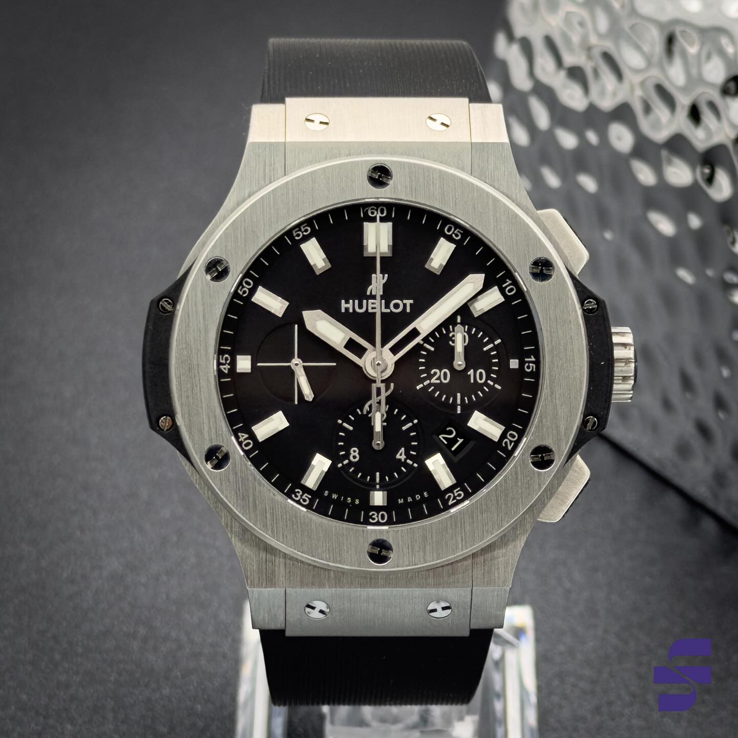 SOLD - Steel. Swagger. Statement. The Hublot Big Bang (301.SX.1170.RX) blends satin-finish stainless steel with black ceramic for a distinctive 44mm case. Its black dial is equipped with luminescent hands and markers, three chronograph subdials at 3, 6, and 9 o’clock, and a date window nestled between 4 and 5 o’clock. Visible through the sapphire caseback, the automatic HUB4100 movement powers the watch at 28,800 vph with a 44-hour power reserve. A black lined rubber strap with a folding clasp completes the look, providing comfort and durability. Whether you’re expanding your Big Bang collection or adding your first Hublot, this model offers wrist presence, performance, and unmistakable style.