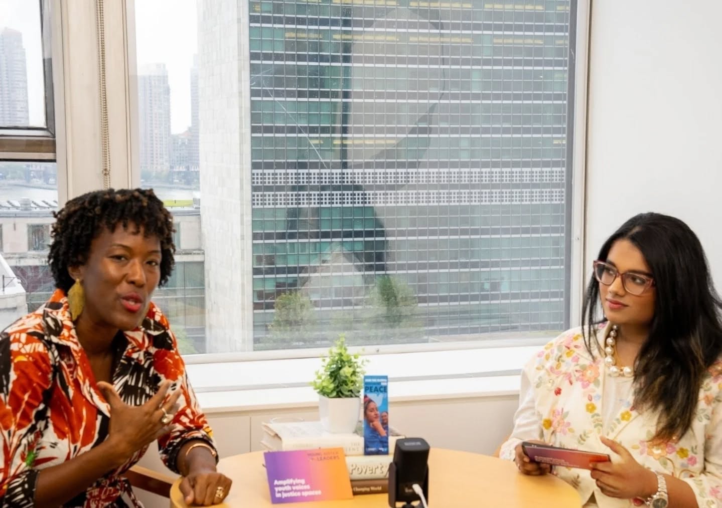 A new podcast on the horizon, featuring the most brilliant justice leaders from around the world, filmed against the backdrop of the United Nations.
There’s something about New York, the quiet corners of cafés,streets echoing with the hum of endless conversations, the reminders to 'be kind' tucked between the unforgiving lanes of the concrete jungle.
Somewhere between all that motion, I found myself thinking AGAIN about the women rebuilding peace in places the world rarely looks, the ones who do the work without the spotlight.
✨️I’ve always believed in the power of conversation, no matter the medium it helps us break silos, challenge echo chambers, and build understanding across generations.So after authoring books, releasing music albums, and now doing my second podcast.I set out to explore what justice looks like when we finance it differently, when we invest in women, youth, and local actors driving peace from the ground up.
I had the honour of sitting down with Tonni Brodber, Head of the UN Women’s Peace and Humanitarian Fund Secretariat, to talk about transforming the global architecture of aid, from project-based support to trust-based, locally led investment in women’s organizations advancing peace, recovery, and justice in crisis contexts.
A woman peacebuilder working on the frontlines has less access to funding than the average short-term consultancy in a global capital.
Want to know the numbers?
Women led organizations receive less than 1% of aid allocated to peace and security.And yet, it is their leadership that sustains communities long after the world’s attention has moved on.
🤝The WPHF model challenges traditional hierarchies of funding, proving that sustainable peace emerges when resources meet lived experience, not bureaucracy.
Tune into this special episode of our limited podcast series, ‘Conversations With Young Justice Leaders’
Now live on all major streaming platforms.
@unitednations @wphfund
#PeopleCenteredJustice #investinwomen #Peacebuilding #GenderEquality #GlobalGoals #JusticeForAll