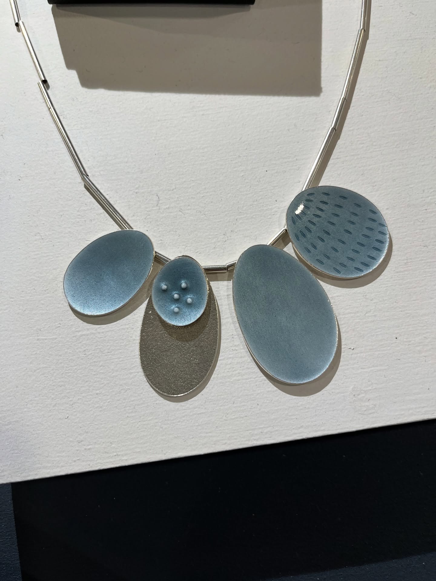Cluster 5 necklace in cool grey enamel and silver - available on my website.
#silverandenamel #enamelnecklace #designermaker #coastalinspired