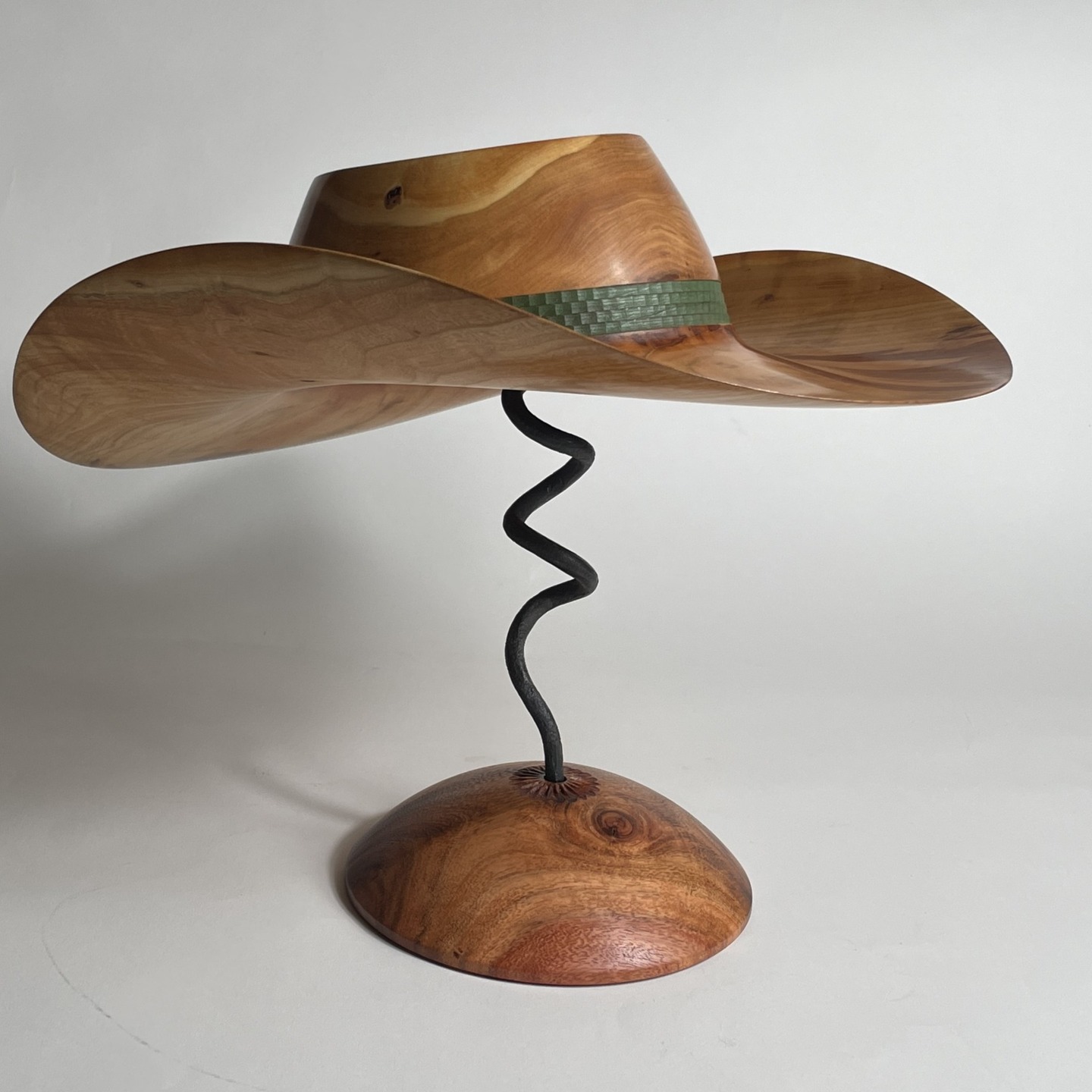 This is the 2nd hat from the Flowering Cherry I harvested this fall. The trees were tagged as in severe decline and it was all I could do to get this hat hence the name. "Low Rider" Lots of diameter but not much depth to work with. 17.5" brim weighs in at 11 ounces and is hat #75 The band was created on the Rose Engine using a 3/16 slot cutter and a 24 bump rosette when the wood was wet before hollowing the inside. Finished with Danish Oil followed with about 5 coats of wipe on poly.
darawoodworks.com