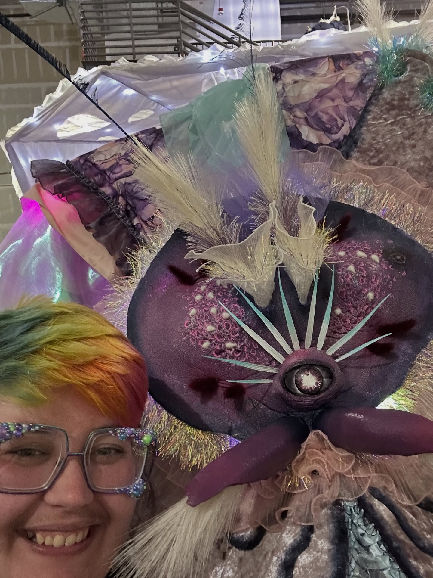 My #throwbackthursday this week is a much more recent project, wherein I served as the Puppet Artisan (and Puppet Wrangler, lol) for @omegamartusa ‘s summer show Phenomenomaly!
MW commissioned the giant werm puppet from the @thecolossalcollective who designed, built, and sent us this beautiful beast! But when OM needed to customize the puppet to function in our space, I stepped in to rebuild sections of the inner structure. The AD also requested a makeover on the faceplates, so new eyes, mouth tendrils, tiered antennae, and several layers of ribbon, tinsel, and paint went on to make this mama werm POP in our factory!
During the run of the show I also had the good fortune to create some of the werm choreography, and lead puppeteering rehearsals with a supremely talented team of ladies who brought this behemoth puppet to life!
#magpiedesign #immersivedesign #puppetdesign #experientialart #spatialstorytelling #fabricationart #productiondesign #installationart #artistsofinstagram #lasvegasart #theatredesign #designbuild #meowwolf #meowwolflasvegas #omegamart #phenomenomaly