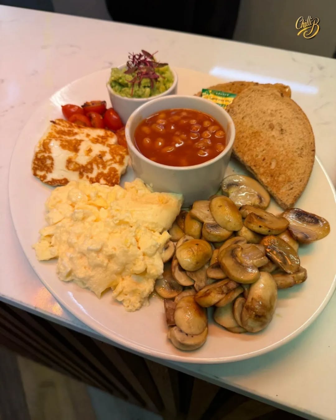 The ultimate veggie feast that’s worth celebrating! 🎉 Say hello to **Love Vegually** – packed with halloumi, roasted tomatoes, mushrooms, smashed avocado, baked beans, eggs & toast. It’s the kind of goodness that makes you smile! 🌱😊
And guess what? Tomorrow is the Hitchin Christmas Lights Switch-On! 🎄✨
Join us this Saturday, 15 November, soak up the festive magic right here at Chilli B Hitchin 💛 We’ll be open till 7 pm, serving food, drinks & mulled wine 🍷 — the perfect warm-up while you watch the lights sparkle across town!
Bring your friends, bring the vibe – we can’t wait to see you! 🤝
#ChilliB #Hitchin #LoveVegually #VeggieFood #Halloumi #HitchinChristmas #ChristmasLights #FestiveHitchin #MulledWine #WeekendVibes #Hertfordshire #Foodie #SwitchOnHitchin