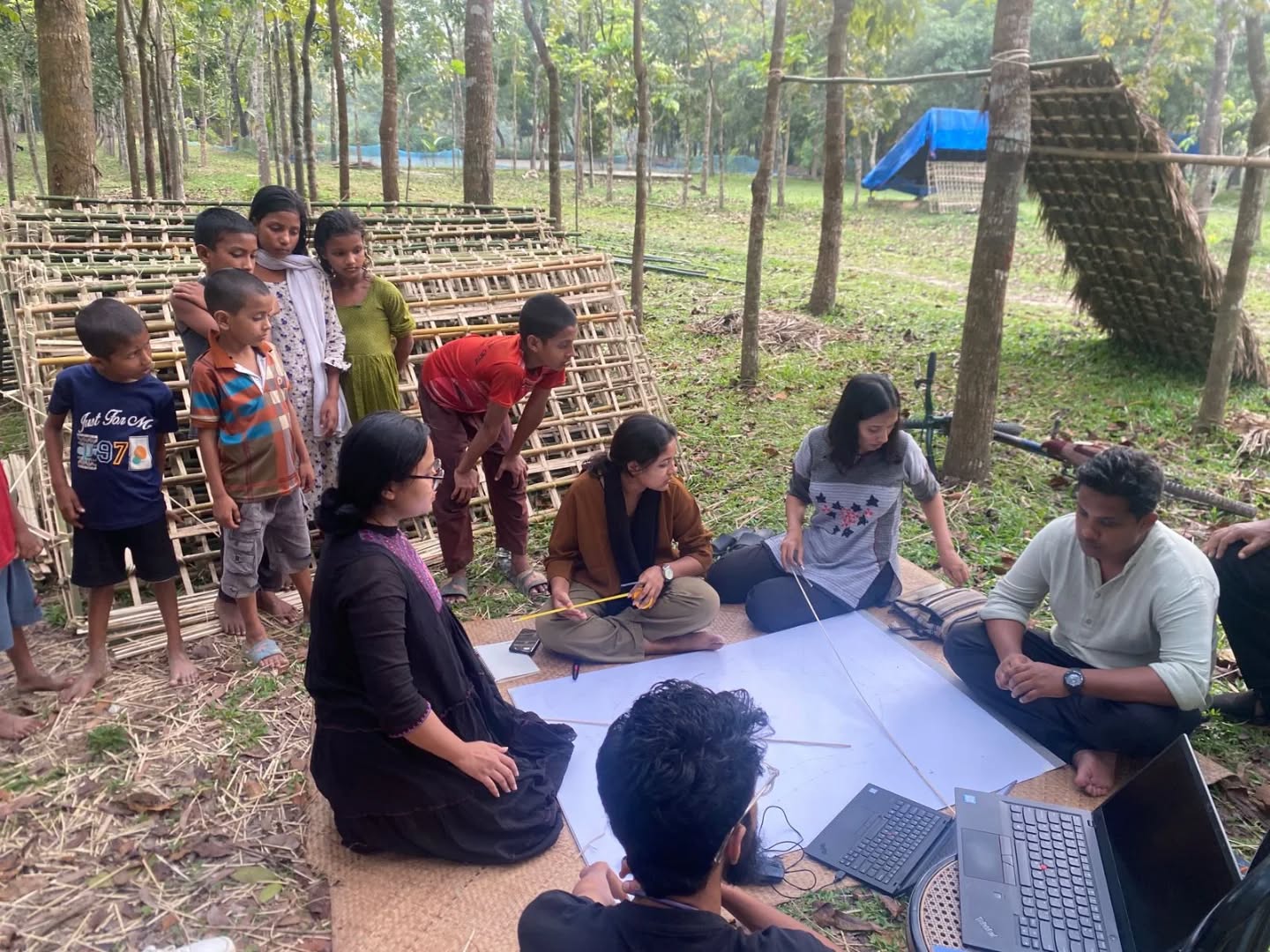 This week at Srihatta, female artisans and architecture students have come together in an experimental workshop guided by Rizvi Hassan, Aga Khan Award-winning architect and a collaborator of the Dhaka Art Summit 2023.
Rizvi has been working with the artisans and students for the past year and a half, nurturing a dialogue between design, material, and community. In this ongoing phase, participants are creating mockups and experimenting with leaves, mud and bamboo to explore how natural materials can inspire new, sustainable ways of building and imagining space. Each collaboration unfolds as a conversation, between skill and curiosity, tradition and experimentation.
This process of Crafting Togetherness celebrates learning through making, and the quiet strength of building with care, together.
This project is supported by the Samdani Art Foundation and the British Council under the Climate Futures South Asia Programme 2025 Grant.
#CraftingTogetherness #Srihatta #RizviHassan #BritishCouncil #ClimateFuturesSouthAsia #SustainableDesign #experimentalarchitecture #WomenInCraft #CommunityArt #Climatechange #SamdaniArtFoundation
#DhakaArtSummit