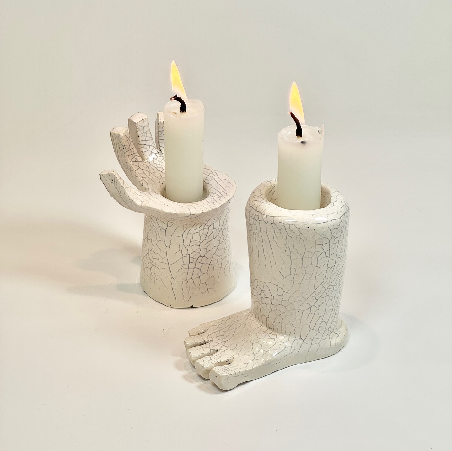 Hand and foot candle holders. Hand formed from low fire clay with crackle glaze.