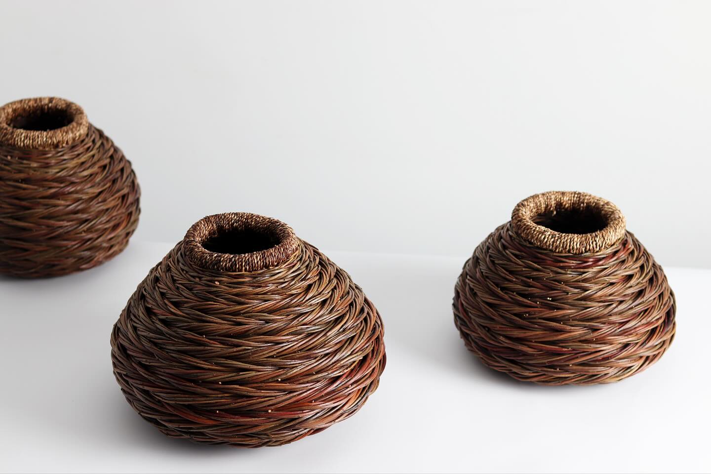 Serving as a record of the changing seasons, this new series of herringbone vessels began in spring; gathering hundreds of dandelions which were growing in the grass between the willow beds.
These were slowly dried in the sun over summer, before being twisted into long lengths of cordage in autumn; used to bind and wrap the wide rims of three of these pieces, resulting in silhouettes which echo ancient ceramic forms.
To view the full body of work, follow the link in our bio.
Sarah