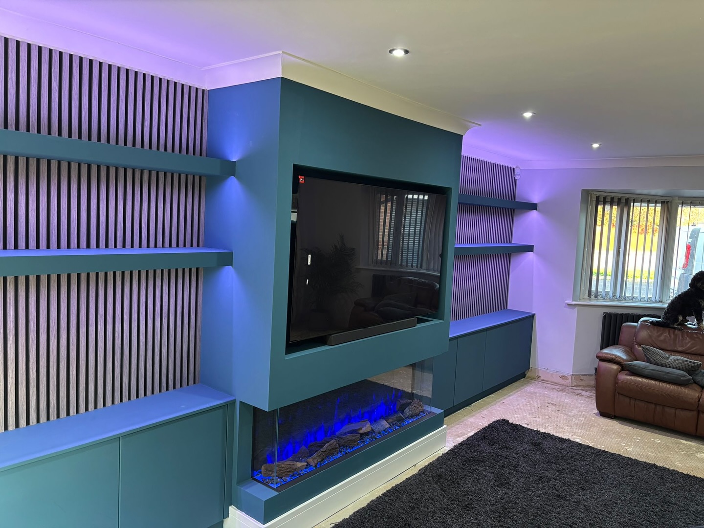 This recently completed media wall project involved the removal and safe capping of an existing gas fire, followed by the construction of a bespoke faux breast to accommodate a panoramic electric fire. Custom-built cabinetry and illuminated shelving were added on either side to enhance both functionality and visual appeal. The installation was then completed with acoustic panels.
#carpentry #bespoke #mediawall #homeimprovement