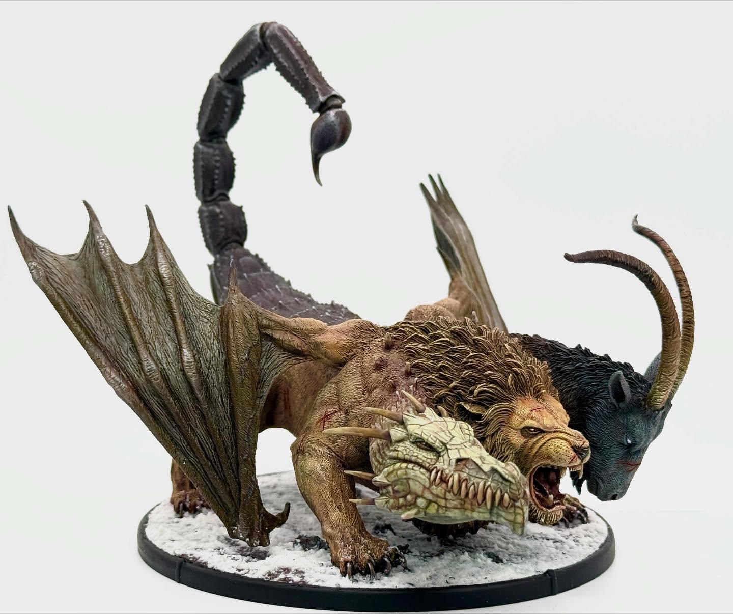 Mierce Minatures awesome Chimaera Terror of Fortriu. Lots of burgundy and other colours in shadows. I also tried to subtly include tones of each head and main animal part in the other parts. I like how its wing knuckle is just scraping and lifting off the snow.
#mierceminiatures #chimaera #mythicalbeast #commissionpainting #paintingminiatures #wargaming #tabletopgames #tabletopminiatures #miniaturepainting #minipainting #miniwargaming