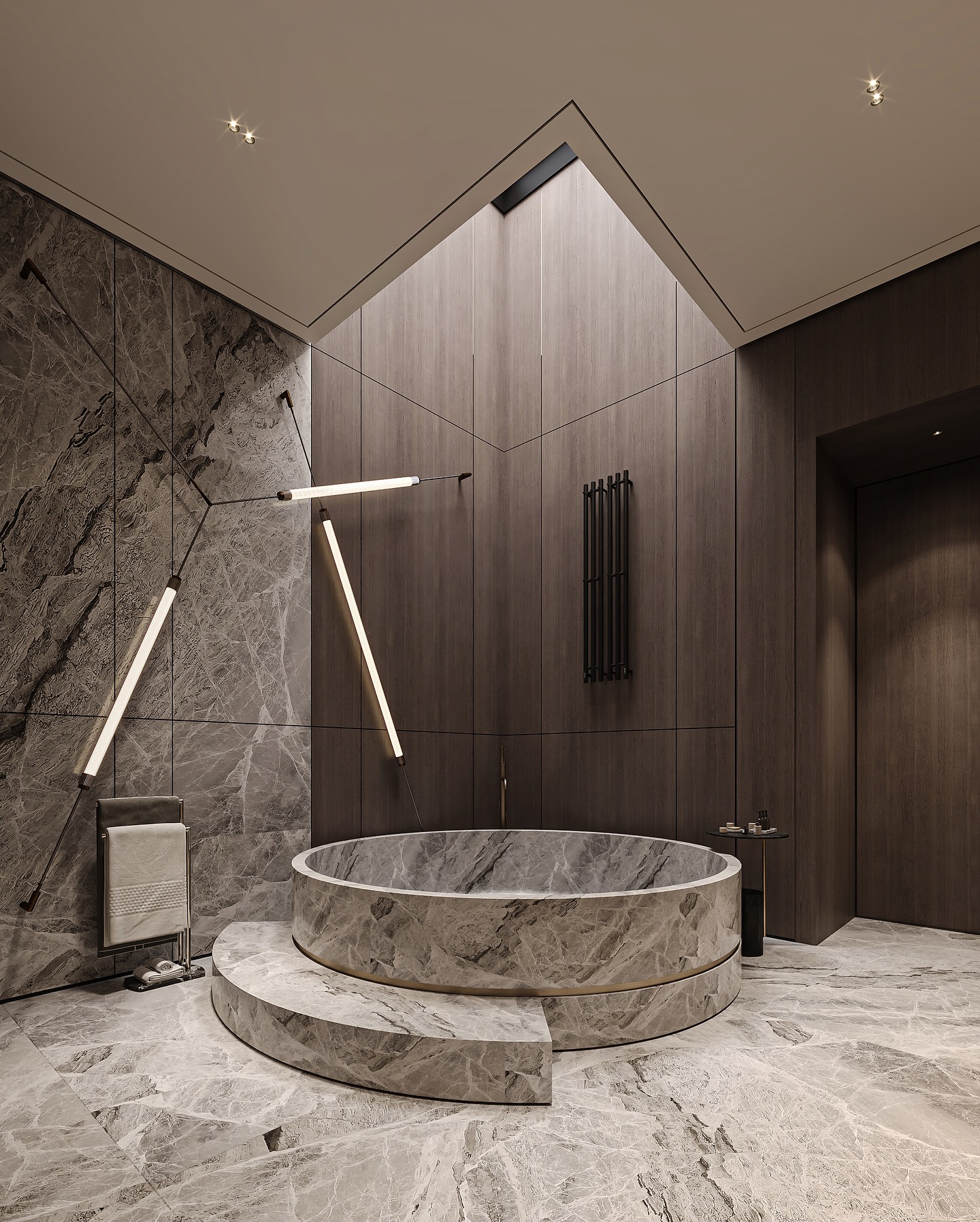 In the heart of Riyadh, this private sanctuary redefines modern Saudi luxury through a dialogue of stone, light, and silence.
Natural marble unfolds across the space in calm, sculpted layers, while warm linear lighting traces the architecture with effortless elegance.
At its center, the circular soaking tub stands as a contemporary sculpture, celebrating balance, purity, and the refined stillness that shapes today’s luxury homes in Saudi Arabia.
Textured stone, brushed brass, and soft timber harmonize to create a sensory retreat crafted for serenity and timeless beauty