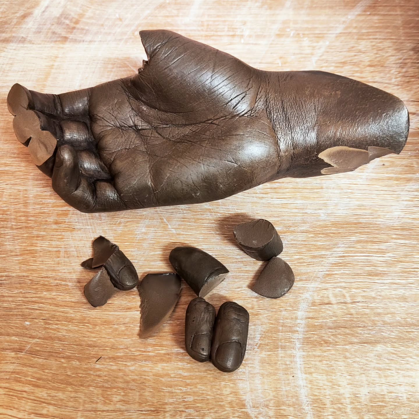 Oops. This memorial cast had an accident and has been brought to me to repair. Obviously the family, are absolutely devastated. Whilst, cold-cast is much stronger than plaster, it can still break.
But thankfully it breaks quite cleanly, so I will be able to repair it. Luckily most of the pieces have been found and then I will remould and we will also make a foundry bronze version which will not break.
I'll always advise clients to go for pure bronze for memorial casts like these because I know how much they mean for people and the amount of handling they get. But sometimes budgets don't always allow.
However I am happy to be able to help save this moment as it is the only copy and will get it so you would never know it was broken 💔