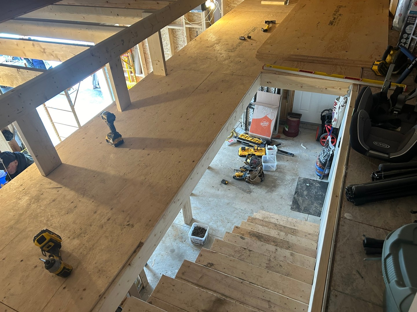 We turned this busy garage into a much more usable space with a new custom mezzanine and sturdy set of stairs.
A solid plywood floor, strong framing, and reinforced supports mean plenty of extra storage — and no wasted headroom in this workshop.