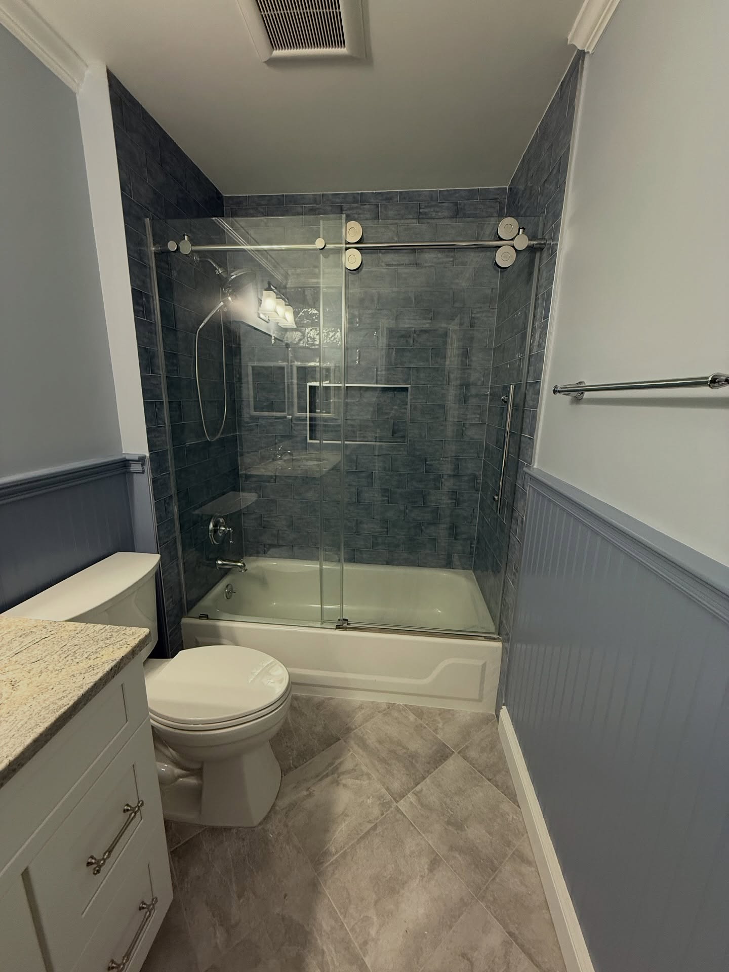 Hallway Bathroom Refresh!
This bathroom did receive a good overhaul but not everything was completely changed in this renovation.
While we installed new tile floor, and tile on the tub walls, we kept the tub and then installed new plumbing fixtures and shower door.
And while we gave her a new vanity, we kept the counter and sink from her old vanity because she loved it, so we selected tile to still let it shine!
Lastly, we kept the bead board on the walls but painted it to compliment the blue in the tile and counter.
What Home Improvement Project can Solimine Contracting help you with in 2026? 203-778-9385
#bathroomdesignideas #bathroominspiration #bathroomtilesideas #bathroomremodeling #bathroomremodel #bathroomstyle #bathroomgoals