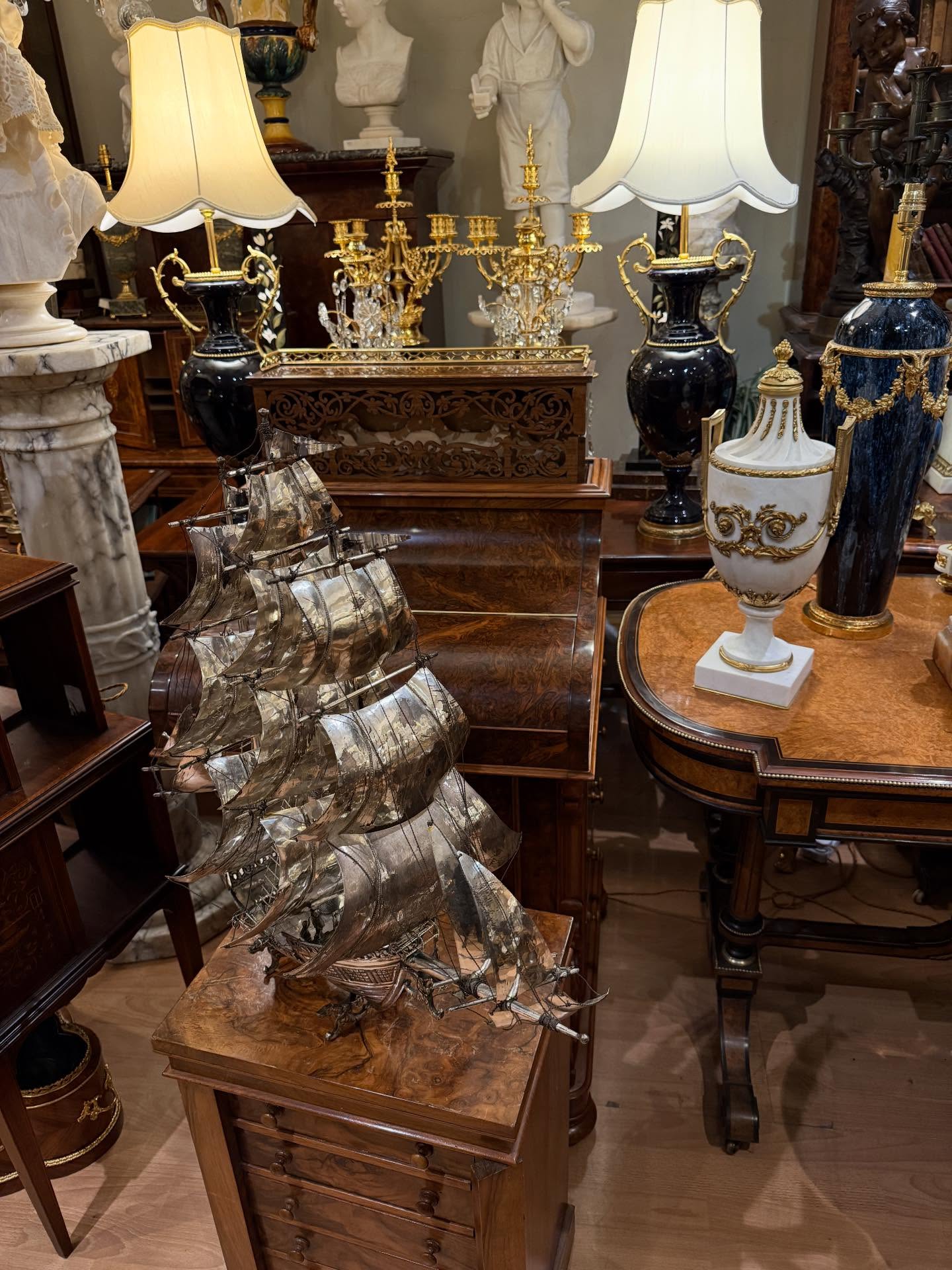 Various antiques in a corner#model galleon#table lamps#sculptures#furniture#portobello