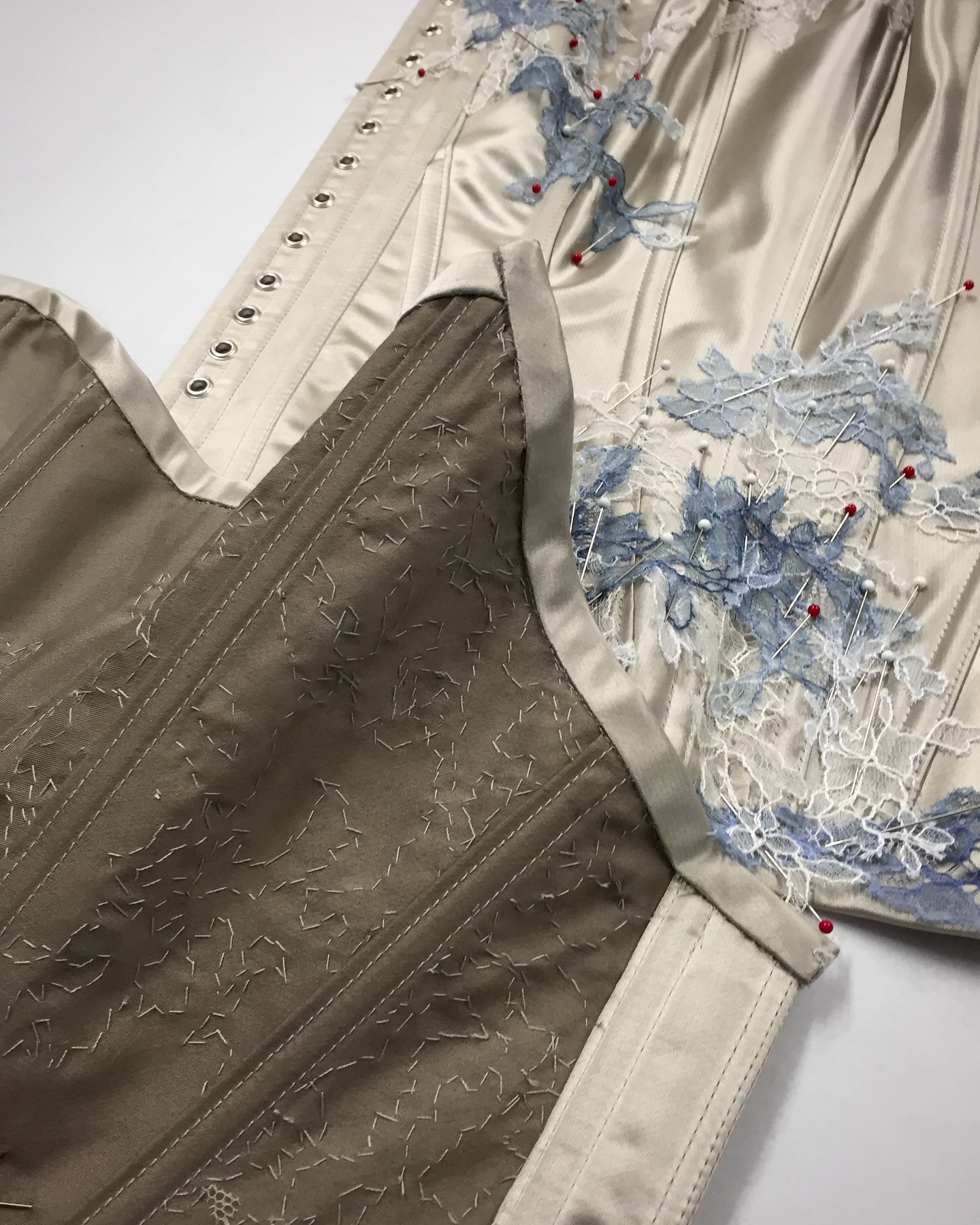 • Floe •
This was one of my first corsets, and of course I didn’t begin with something simple!
Ten years ago, for my final major project at university, I collaborated with @sparklewren, whose distinctive techniques shaped the whole collection.
I knew I had to include a corset made with her refined lapped-seam method: two layers of fabric folding over and under itself - which was achieved with specialised attachment on a twin-needle machine - to create clean, sculptural seams that doubled as boning channels. The result was a piece that felt exceptionally light and impeccably finished, inside and out.
It was demanding to learn, but as a budding maker, I was proud of how far it pushed me! I’d love to revive those skills someday.