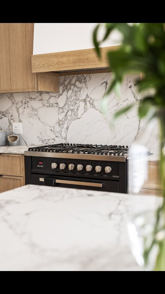 A kitchen where refinement meets warmth in every corner.
From the sculptural marble-veined waterfall island to the seamless oak cabinetry wrapping the entire space, this kitchen is all about curated simplicity. The glass-front display unit adds a touch of boutique elegance, while the matte black accents and integrated appliances ground the design with modern edge.
A space designed to be lived in beautifully.
#KitchenDesign #ModernKitchen #LuxuryInteriors #InteriorInspiration #KitchenInspo #MarbleIsland #WaterfallIsland #OakJoinery #ContemporaryLiving #DesignerKitchen #JoineryDesign #ModernInteriors #KitchenGoals #SouthAfricanInteriors #camiinteriors