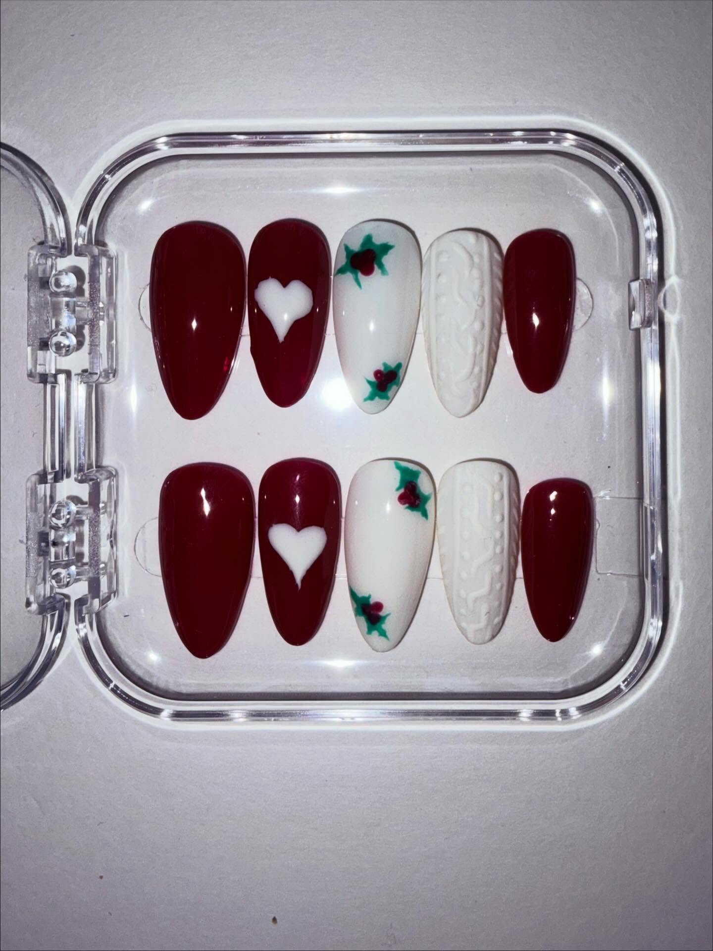 Rec and ivory hand painted Christmas sweater themed press on nails - Christmas nails with holly and Christmas sweater nail art #nailsnailsnails #nails #christmasnailart #handpaintednails #christmas #nailtrends #christmasnails #winter