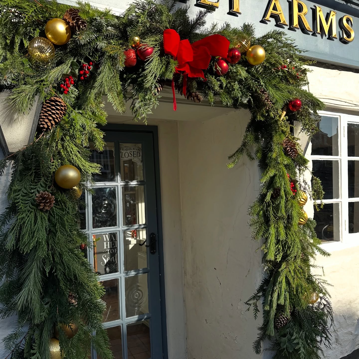 Festive period ready at our lovely local pub @theoakleyharrold . We loved dressing it up - it is so festive inside and out now. Thanks Rachel @untamed_florals for the help. I am so glad I live locally so can see it everyday and also check up on it- the high winds today lead for a few extra ties needed and a kettle bell added for extra weight!