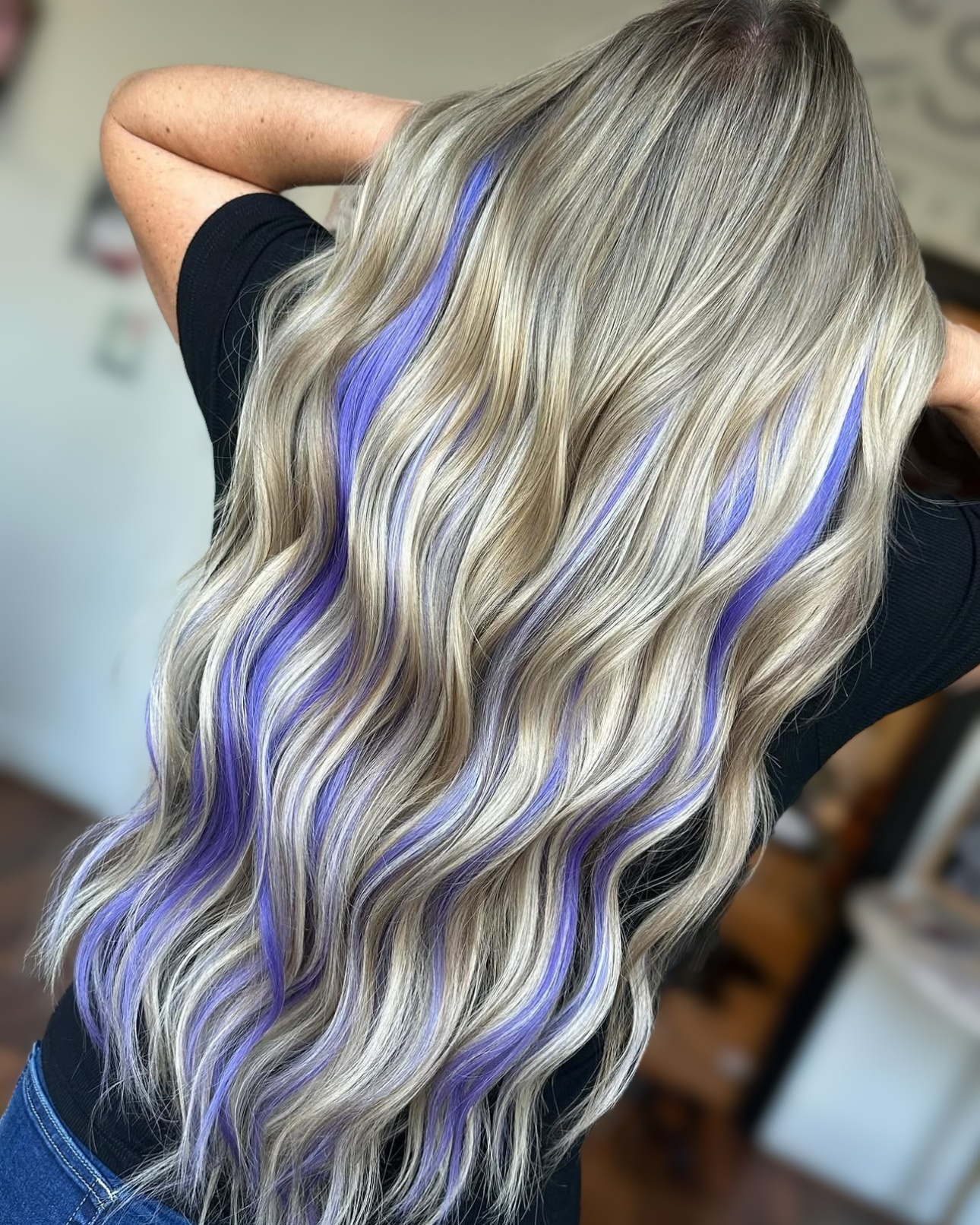 Ribbons of lavender...Master Stylist Charlotte @say.humble.hustle.hair installed two rows of 22" extensions and then added a custom color mix to create these violet pops of color.