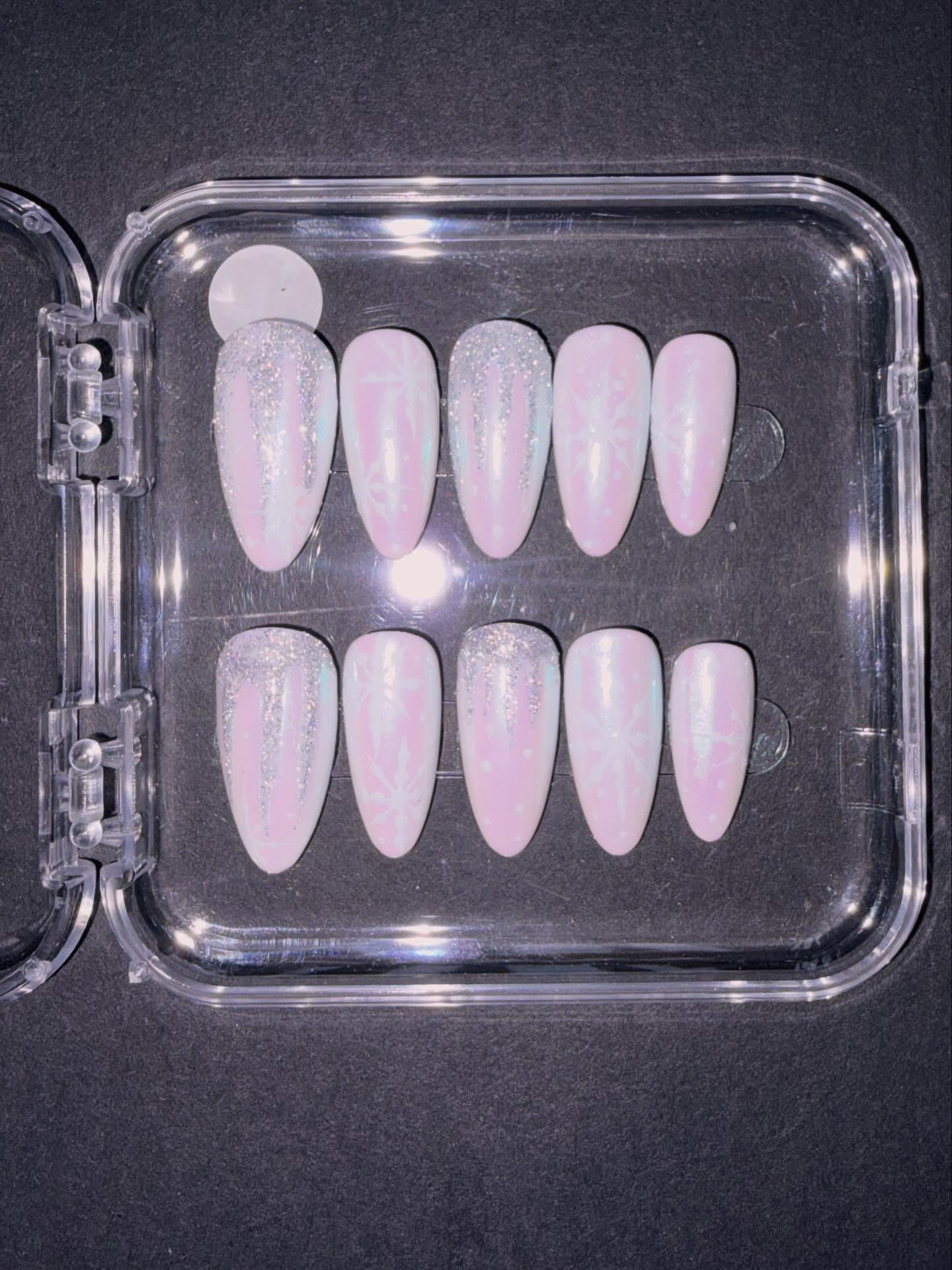 Hand painted Christmas press on nails - snowflake nails in white pearl chrome for the festive season #nailsnailsnails #nailart #christmasnails #handpainted #christmasgiftideas #nails #christmastime