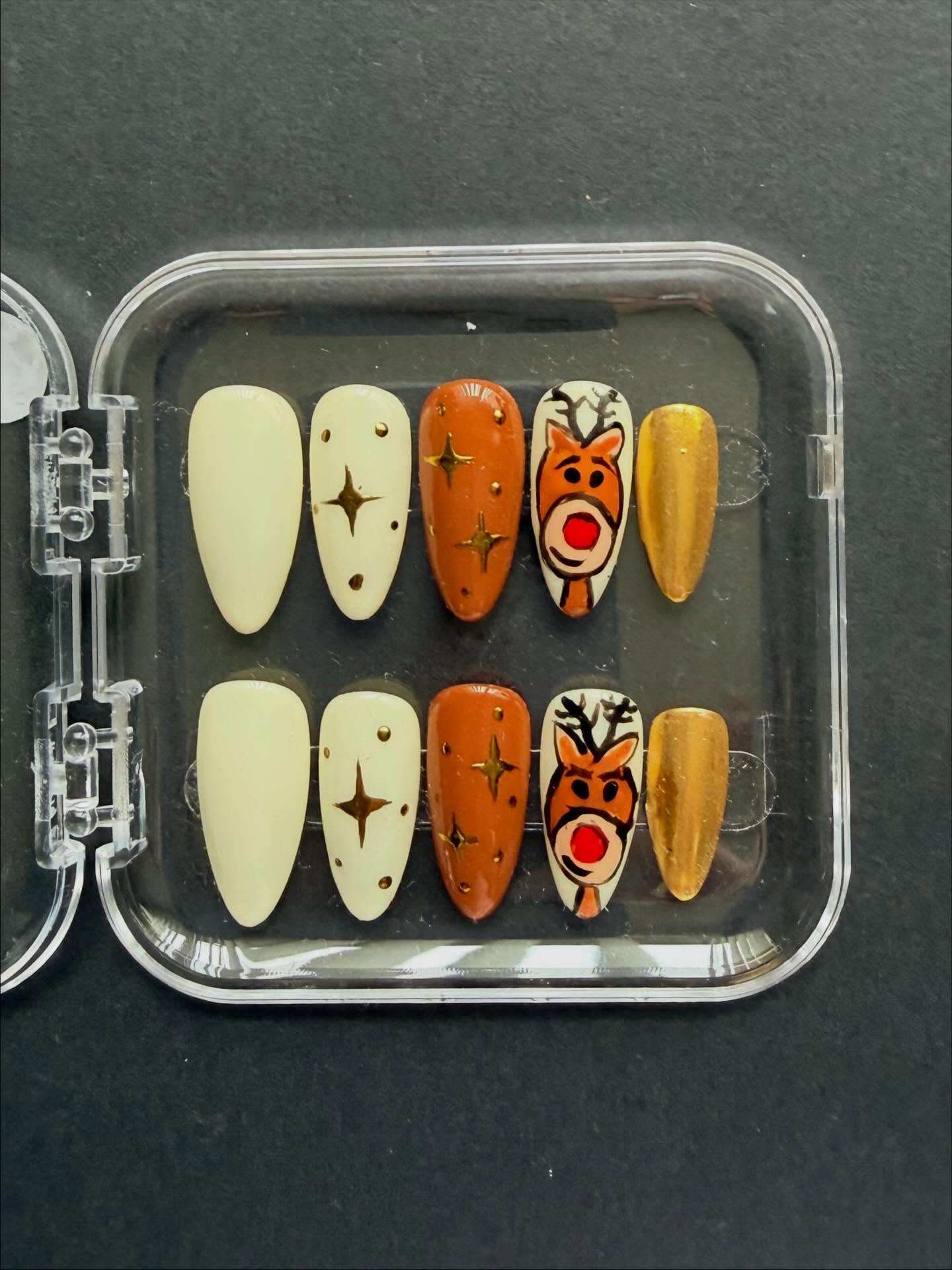 Hand painted Rudolph themed Christmas press on nails - Christmas nails #nailsnailsnails #nailart #christmasnailart #handpaintednails #rudolph #christmas #nails #nailartist #christmasnails