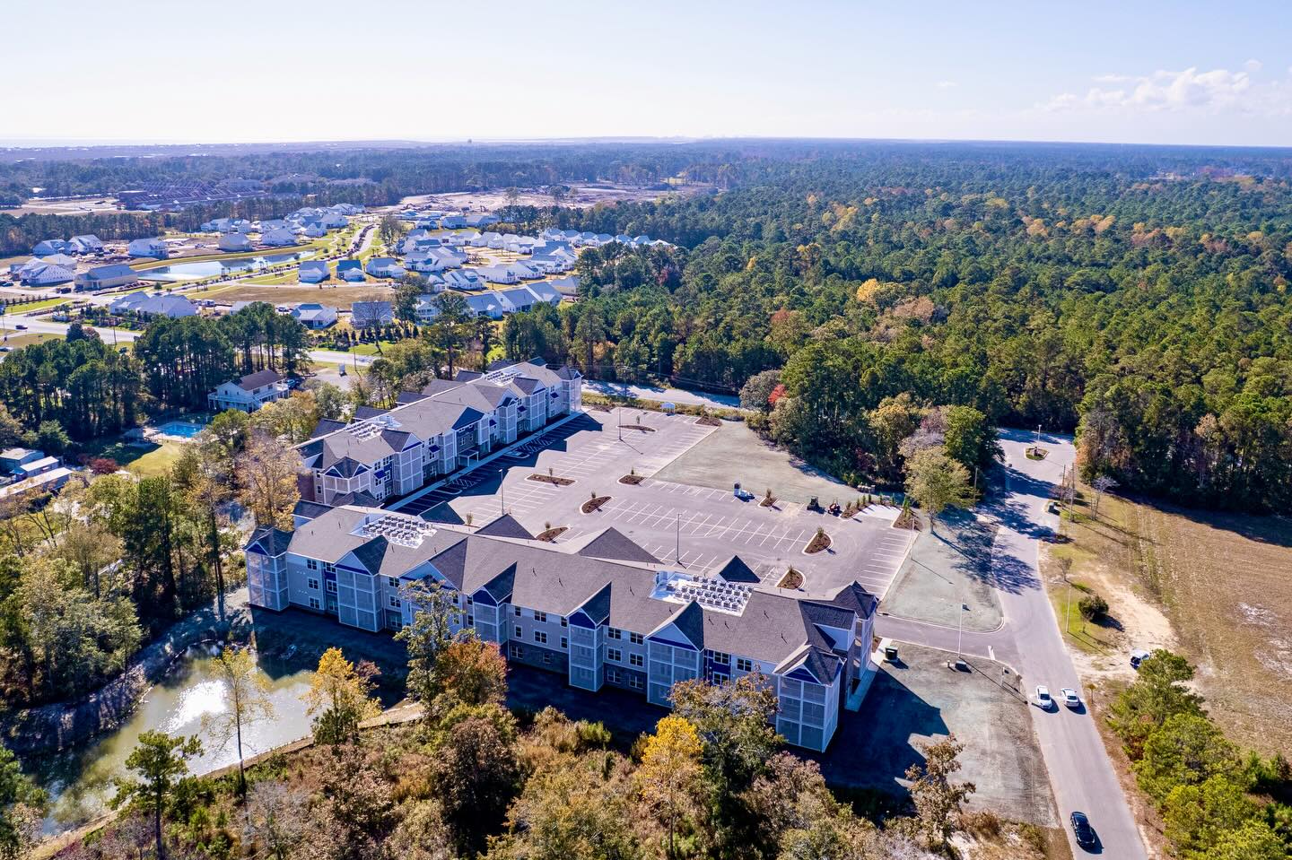The Geis Construction team recently completed a new multi-family project in Sunset Beach, North Carolina. The beautiful active-senior living complex, known as Beacon Landing has 108 apartments and is a diverse mix of one-, two- and three-bedroom units, each equipped with full kitchens, new appliances, screen-in porches and high-end finishes. There are also spacious lounges and community rooms, a fitness center, leasing office, and a dedicated nurse clinic designed to support a vibrant, healthy, and engaging lifestyle. Interested in calling this home; please reach out to Property Advisors Group to learn more about leasing opportunities or feel free to visit https://pagcommercial.com/beacon-landing/