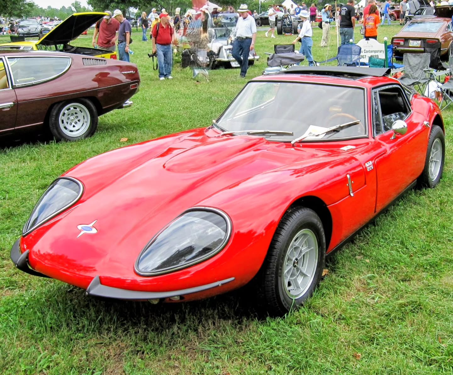 Wooden chassis and Ferrari-esque curves in the Bluegrassâthis little red Marcos stole the show at Keeneland Concours dâElegance in Lexington, KY. Under that sleek fiberglass body is a marineâplywood monocoque chassis, glued together from hundreds of pieces to be ultraâlight and surprisingly strong, just like a race car built by a master carpenter. From the long nose and tucked tail to the low roofline and side vents, the lines have serious Ferrari vibes, but this is a boutique British kitâcar oddball that weighs around 1,800 pounds and feels every bit as focused as it looks. #Keeneland #Cartucky #MarcosGT #WoodenChassis #LexingtonKY #KentuckyCarCulture #KitCar #BritishSportsCar