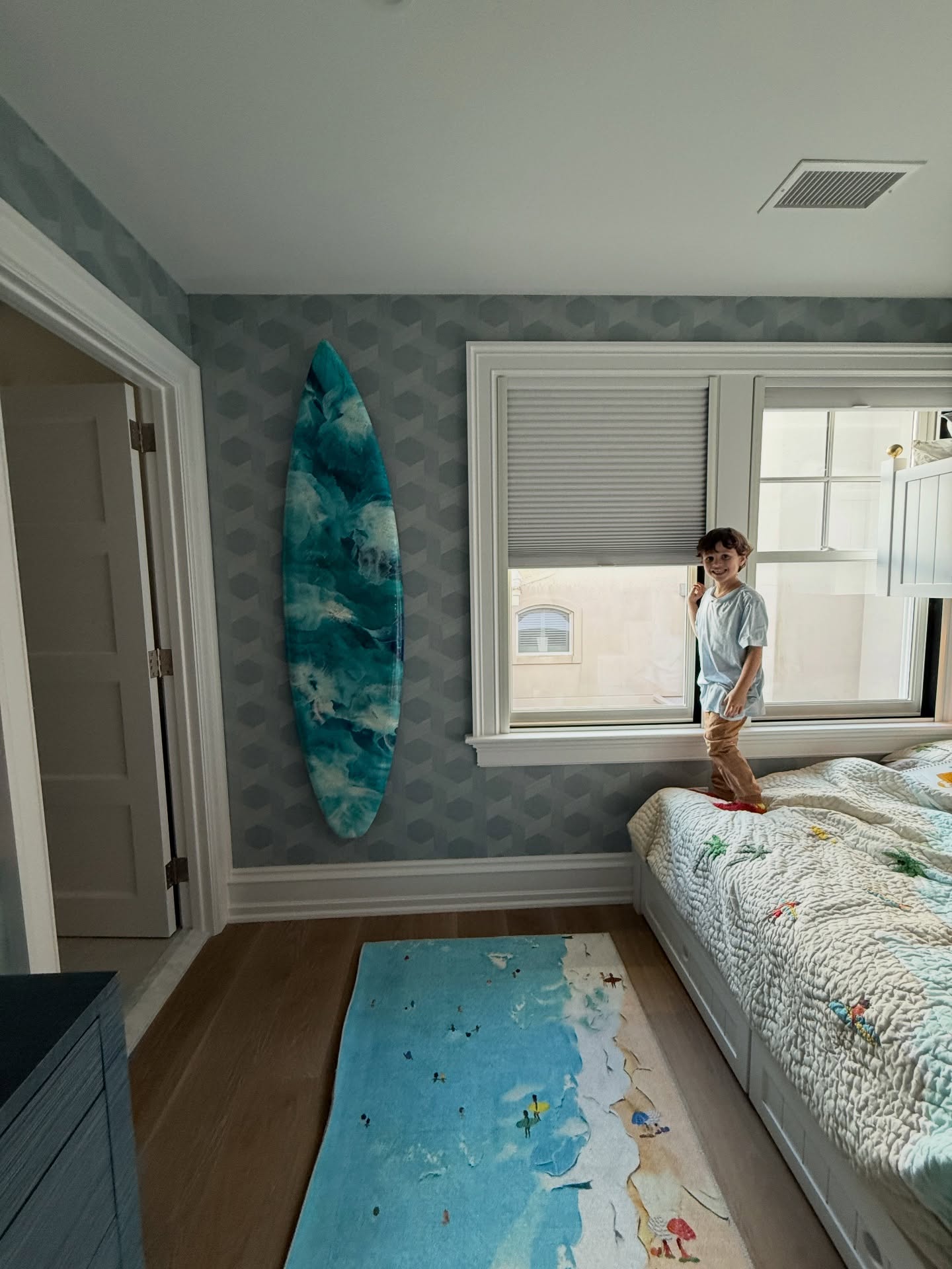 Custom surfboard! Perfectly whimsical addition to a beach house bedroom!