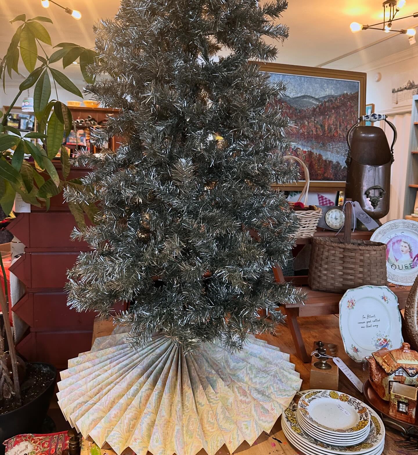 No tree skirt?
Make your own.
I did an accordion fold with a vintage wrapping paper.
Paper hole punched the top, threaded a zip tie in and wrapped / secured at the base of the tree.
Perfectly simple.
A great DIY solution.