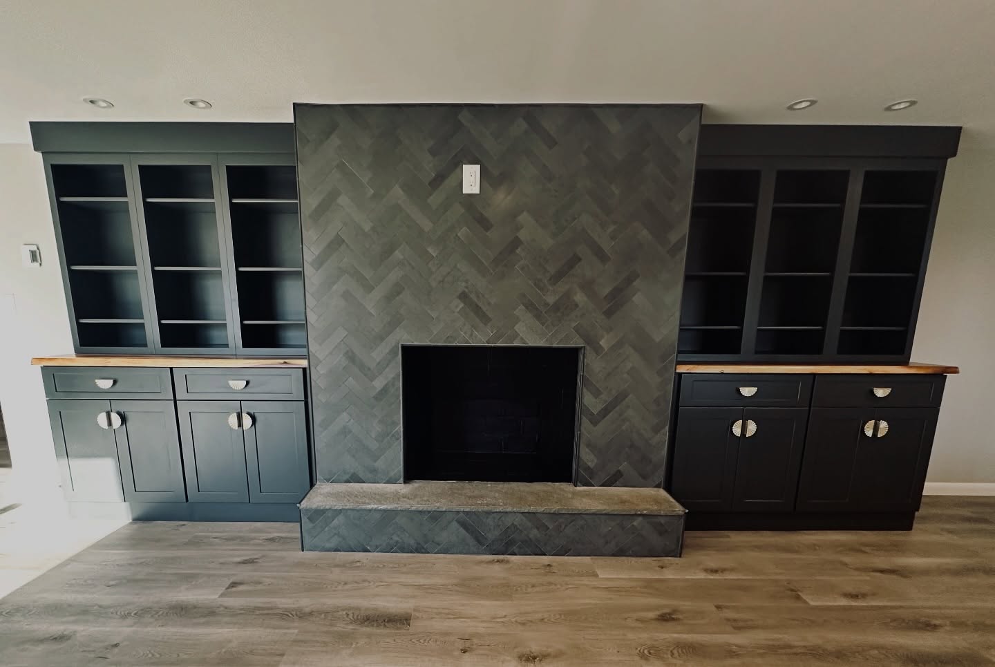 Make sure you swipe to the end to see how this basement was COMPLETELY TRANSFORMED!
We took a dark and dated basement in this ranch home and turned it into an inviting family room for all to enjoy!
• Removed the paneling from the walls and installed new sheetrock throughout
• Installed Vinyl Luxury Flooring on the floors
• redesigned the fireplace with floor to ceiling herring bone tile and new built-ins with @fabuwood cabinetry on either side of the fireplace
•Installed new bar cabinetry against the wall to optimize flow and functionality in the space
The homeowners were a little nervous about the dark cabinetry that it was going to make to space dark still but with the right material selections including paint and new recessed lighting throughout to compliment the cabinetry, you would never think this space is dark.
Sometimes you just need to trust the design process and watch the transformation happen!
What home Improvement Project is on your mind for the New Year? 203-778-9385
#basementremodel #basementrenovation #basementdesign #vlf #fabuwood #fabuwoodcabinetry #builtincabinets #barcabinets #homeimprovementideas #homeimprovementprojects #homeimprovementcontractor #homeimprovementdesigner #ctcontractor #ctdesigner #letsbuildsomethingbeautifultogether #smallbusinesssaturday #familyownedbusiness