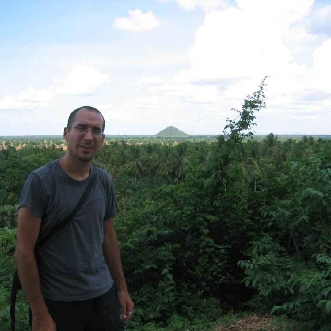 Passage from Travels in the Land of Hunger: A backpacker's earthbound journey from the East to the West 🌏📖
Tuesday, May 18, 2004
... At around two in the afternoon, we arrived in Battambang, the second largest city in Cambodia, but to my Chicago and Tokyo eyes, it was a tiny town. Once I settled into my hotel and had lunch, I hired a moto-taxi (a motor scooter taxi driver) to take me to the killing caves of Phnom Sampeau.
Phnom Sampeau is a limestone mountain with a complex of temples at its summit. After we arrived, I hired a local boy who spoke English to guide me to the infamous killing caves. We followed a path that led up and around the mountain. As we made our ascent, the heat and the climb caused me to sweat tremendously, which attracted legions of mosquitoes.
#TravelsInTheLandOfHunger #travelmemoir #memoirwriting #authorlife #indieauthor #bookexcerpt #writersofinstagram #backpacking #backpackinglife #solotravelers #travelphotography #travelreflections #instatravel #cambodia #cambodiatravel #adventuretravel #traveldiaries #battambang #phnomsampeau #killingfields