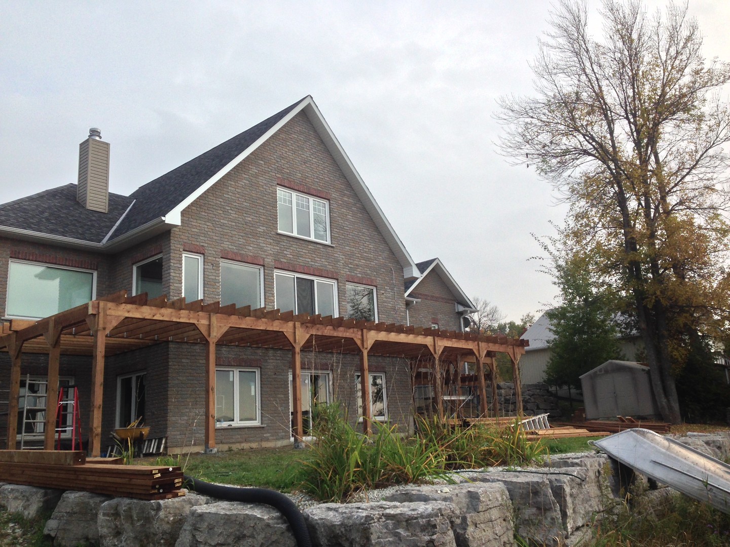Clearly a pre-winter build. Here we were in the middle of transforming this backyard with a custom pergola that spans nearly the full width of the house.
Big beams, clean lines, and sturdy posts—built to match the scale of the home and give these homeowners an outdoor space that’s both functional and impressive.