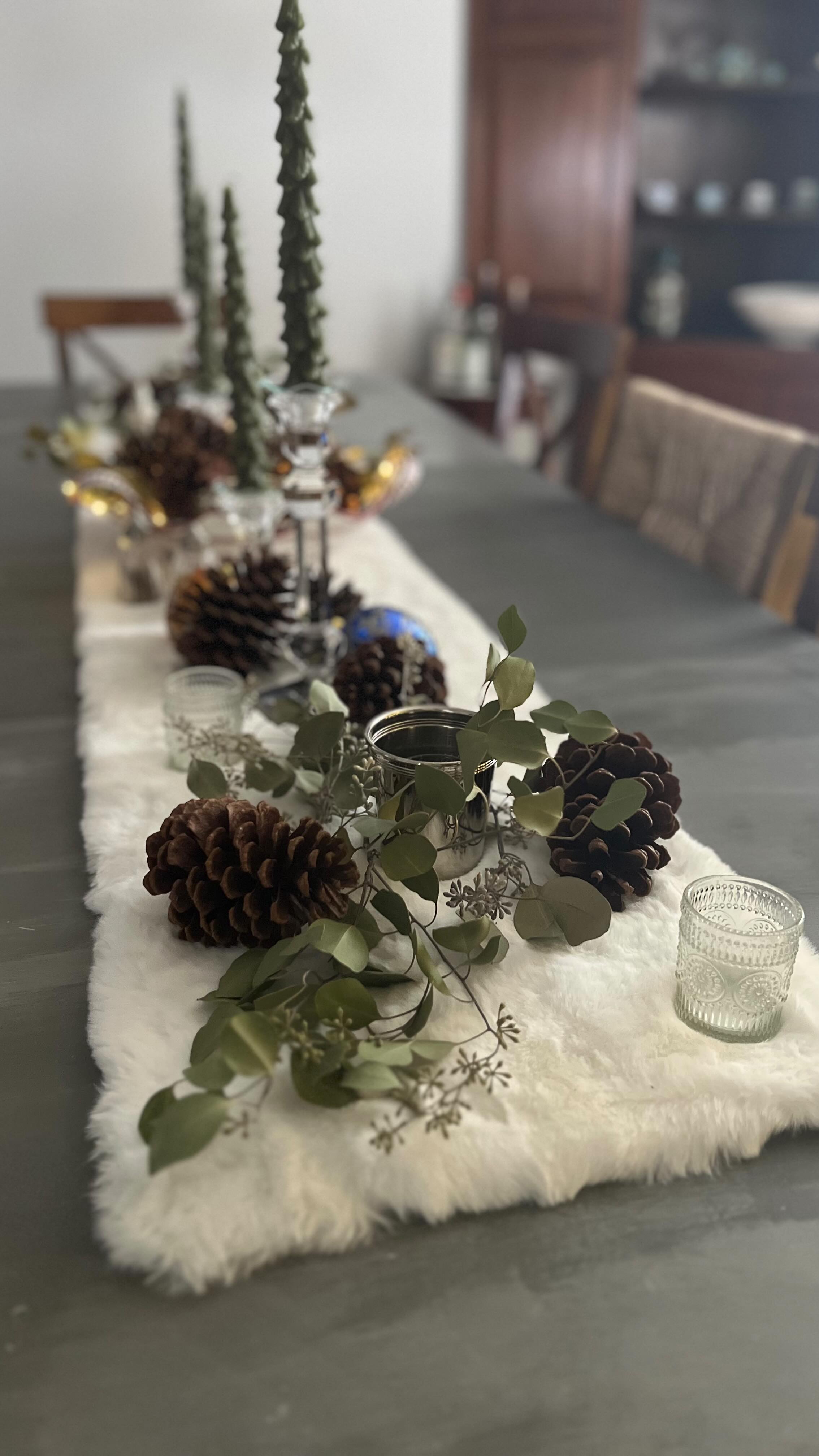 Creating a little winter wonderland right at the dining table
I’m loving how the soft faux-fur runner, oversized pinecones, and fresh greenery come together to make the whole space feel cozy and magical. The glass votives add the prettiest glow, and those tall tree candles bring in just the right touch of height and whimsy.
It’s amazing how a few simple natural elements can transform a room and make it feel warm, inviting, and ready for the season. Here’s to slow moments, soft textures, and spaces that make you want to linger a little longer.
#WinterDecor #HolidayTablescape #CozyHomeVibes #TableSettingInspo #SeasonalDecor #FarmhouseStyle #NeutralHolidayDecor #PineconeDecor #CandlelightGlow #HomeForTheHolidays #SimpleSeasonalStyle #DiningRoomDecor #HolidayInspo #WinterAesthetic #CozySeason #HolidayHomeDecor #NaturalHolidayDecor #TablescapeDesign