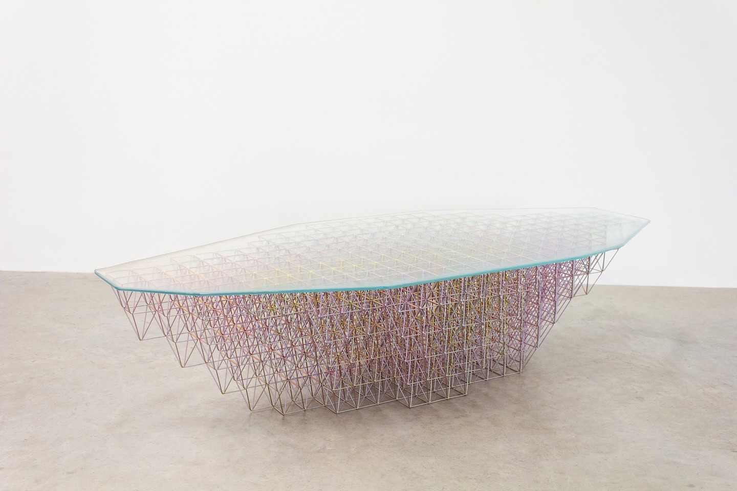 Happy to finally get some images of my Futurity Table 01 made!
Futurity is a collection of experimental furniture made from steel wire and slumped glass. The series started with a fascination for space-frame truss roofs, airplane hangars and radio telescope constructions. Through experiment, I emulate these complex constructions on a small, almost delicate scale. The constructions are then combined with glass in the kiln. The slumped surfaces become table tops and lights. The collection of furniture pieces seeks to bring this fascination of material and structure into interior scale spaces.
‘Futurity’ refers to a phrase, ‘The Collapse of Futurity,’ or the idea that the ability to envision and plan for a distinct future has eroded. I like how the word encapsulates the idea of the future or ‘futureness’. Seeing the changes and rate of change in the world around us, both technologically and politically, I find it ever harder to imagine a distinct future. This confusion stands out starkly against the decidedly clear vision of a future put forth in the space age and I find myself fascinated with the decaying relics of that era.