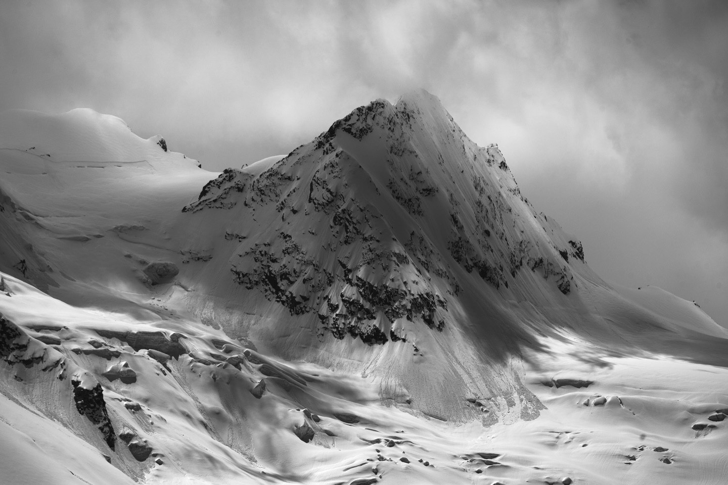Lights, Shadows, and Glaciers.
This is the second image I lately printed for a client in a different format than usual.
During this time of the year, I’m busy with creating a lot of fine art prints for my clients. This image is part of my long term project „Lights, Shadows, and Glaciers“ and the client ordered 3 prints out of the project and upon his request not in the square format I usually print within the series but in a 2:3 aspect ratio. I love both aspect ratios - sometimes the square format reduces or minimizes distraction and in the slightly larger 2:3 ratio the subject has a little bit more room and let’s the eye wander and explore more.
Capturing the intricate details of these glacial landscapes requires precision in both technique and equipment. To preserve the sharpness and texture of the ice, I rely on short exposure times that freeze the subtle motion of the clouds and emphasize the rugged, unyielding nature of the glaciers. Using filters, particularly a Polarizer and the ND3+CPL combination from Maven, allows me to manage reflections and control the light, bringing out the full depth and detail in my images. These tools not only help reduce glare on the ice but also balance the light in high-contrast scenes, ensuring that the glaciers’ intricate patterns are rendered with clarity and nuance.
To emphasize these details further, I chose to photograph the glaciers in black and white. By stripping away the distraction of color, the raw textures and stark contrasts are brought to the forefront. This minimalist approach reveals the true character of the glaciers, their deep cracks, jagged ridges, and the dramatic interplay of light and shadow. It’s remarkable how much more becomes visible when the vibrant hues of nature are subdued, allowing the story of the ice to unfold in its purest form.