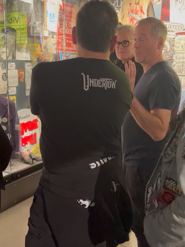 I caught @bbelke_music and @mucb from @snfu_ofishal while giving a guided tour at @thepunkrockmuseum, standing in front of the case that holds artifacts and photos from many of our Canadian friends. It’s one of my favorite places in the museum, and I find myself spending time there on every visit. I miss many of them dearly, and it’s always touching to see others appreciating and honoring the memories they left with us.