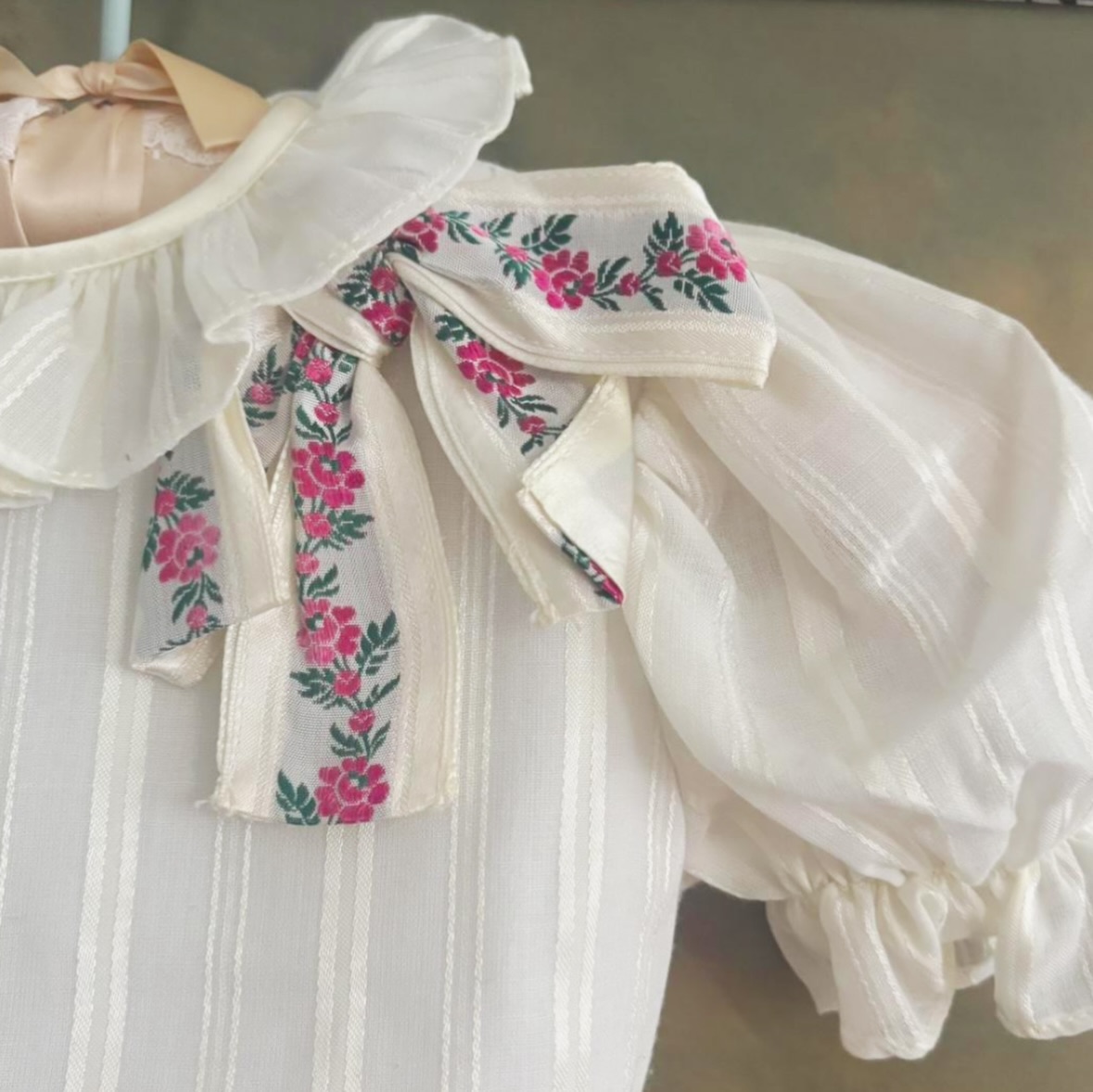 ~1960’s Yves Saint Laurent~
Vintage Yves Saint Laurent dress from the 1960s, crafted in a delicate ivory fabric with soft vertical striping, puff sleeves, and romantic ruffle details. Finished with floral ribbon accents at the waist and shoulder. In pristine, unworn condition — a rare and timeless heirloom piece.
SOLD
#vintage #yvessaintlaurent #childrensclothing