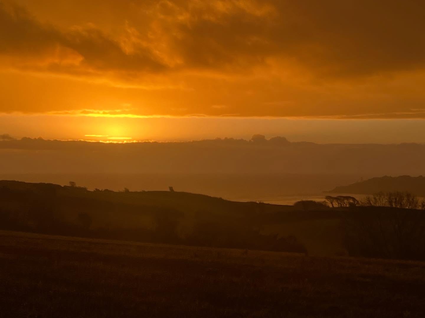 Glimpse of the Sun rising between strips of cloud, even when the rest of the dark skies are releasing their force!!