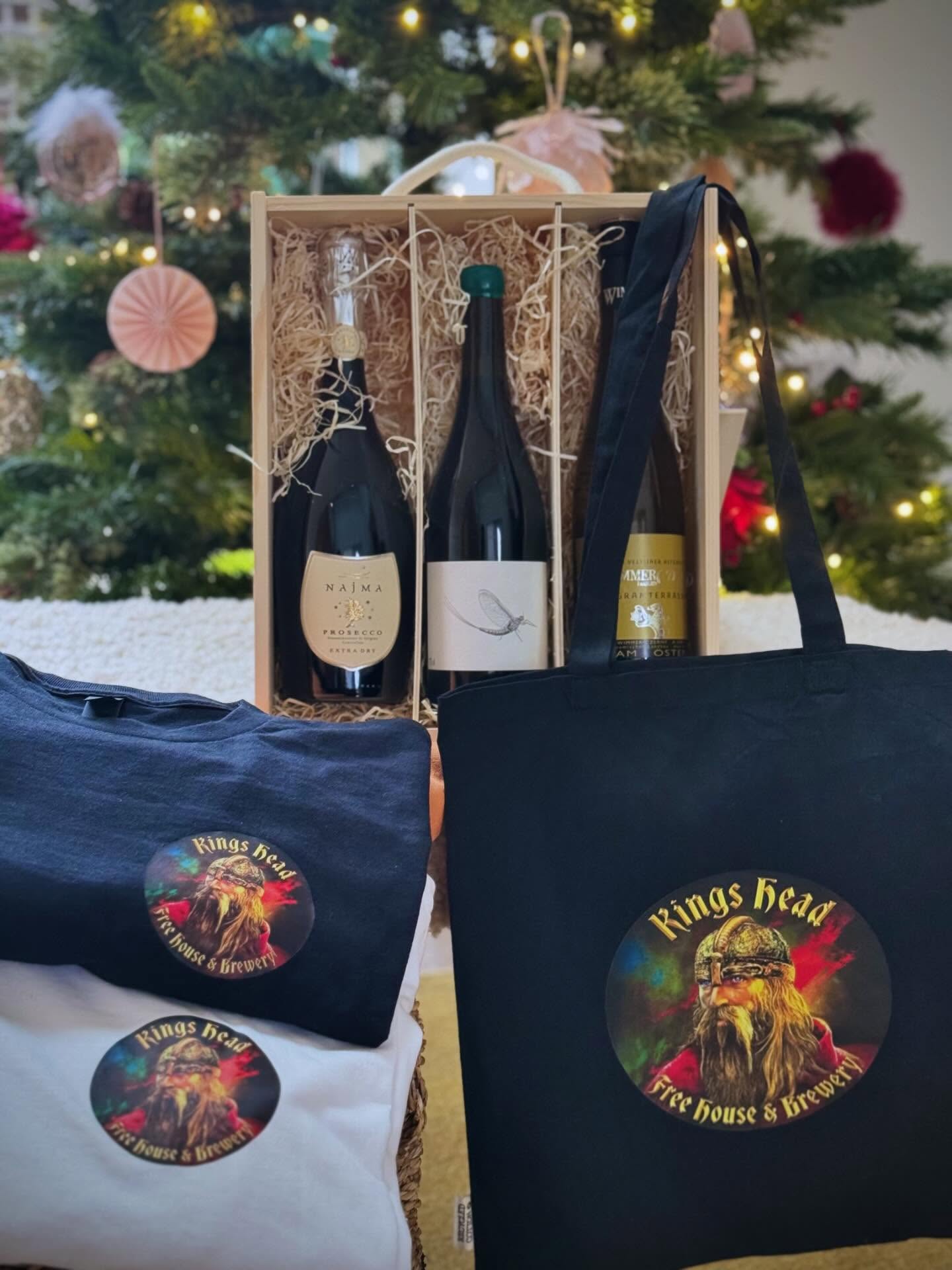 If you’re anything like us, panic will be setting in right about now as you realise Christmas is next week and you’ve still got lots of gifts to get. So for all you last minute Larry’s (you’re in good company), we’ve put together this little bundle of joy that you can pop in and pick up this weekend (accompanied by a celebratory pint or glass of vino no doubt!) or we can send out to you in time for Christmas!
Check out the 3 special gifts in this festive bundle:
- One of our wooden gift boxes complete with kiln dried wood shavings showcasing our 3 Kings:
Najma Extra Dry Prosecco NV
Situated in the foothills of the Dolomites, the Najma vineyards are all family owned and farmed organically by Bettina Cichellero and her son Andrea. Their Extra Dry cuvée is a beautifully crisp expression of the Glera grape, oodles of peach and apricot with a soft vibrant finish.
Gruner Veltliner Wagramterrassen 2023, Wimmer-Czerny
A firm favourite at the Kings Head, the Gruner Veltliner is grown on the famous Austrian Loess soil which gives it a lovely minerality coupled with spice, red apple and greengage. Winemaker Han’s is big in the world of biodynamic viticulture, so this is totally organic and weighs in at a civilised 11.5%.
The Mayfly Syrah 2022, Domaine Lauzeta
This is a limited ‘Mayfly’ edition from our friends at Domaine Lauzeta in the historic region of Saint Chinian in the Languedoc. A classic blend of old vine Syrah, Carignan and Grenache, this is incredibly fresh but with some solid Southern French muscle - black cherry, damson, spice, leather, herby notes of the garrigue, all topped off with a festive green wax seal.
- Fresh off the printing press also in your bundle will be a Gildan heavy 100% cotton Kings Head T-Shirt in your choice of Black or White and available in Medium, Large or XL, plus a 100% Recycled Cotton Kings Head Tote Bag!
This bundle would usually retail (delivered) at £102.50 but as in this case the late bird catches the worm, we are offering this delectable gift set at:
£75
(to pick up at the pub)
£85
(delivered)
To order please email: info@kingsheadbildeston.com