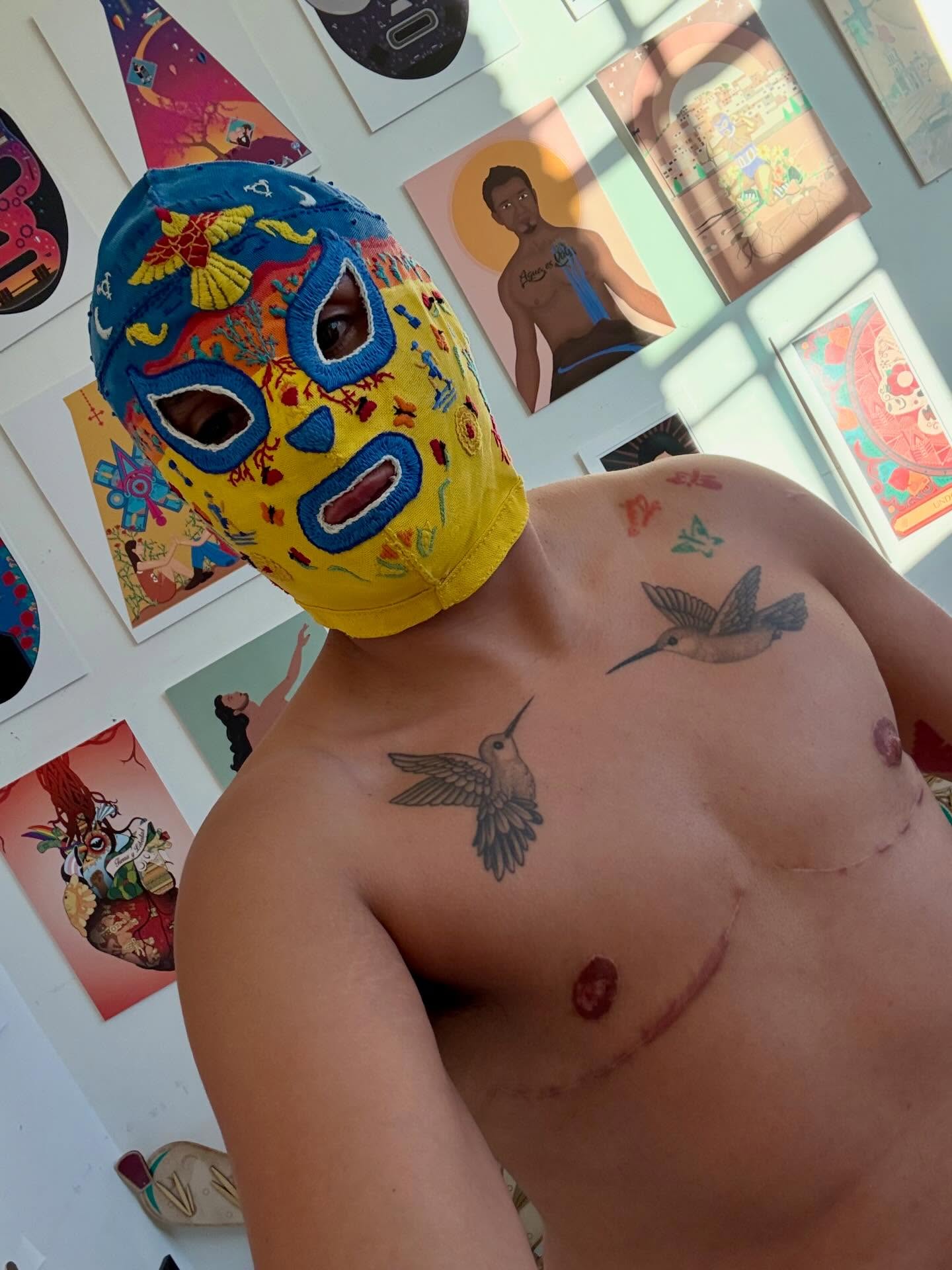 The initial mask for the Lucha Libre Trans Queer Art Espectacular project is finished! I decided to start with my own mask to develop the process for creating the work. Initially, I experimented with different fabrics and paints to determine what would work best. After making the base, I relearned how to embroider.
This mask reflects who I am as an athlete, an immigrant, and a trans person. During this process, I’ve been reflecting on my grandmother. Moving to the U.S. at age seven limited the time I had to know her. I often wish I had more opportunities to spend time with her in our homeland, to learn more about her and myself. I have a few memories of her, such as her teaching me to embroider napkins. She passed away a few years ago, but I’m grateful that this project has allowed me to reconnect with her through those memories and now to share who I am through these techniques.