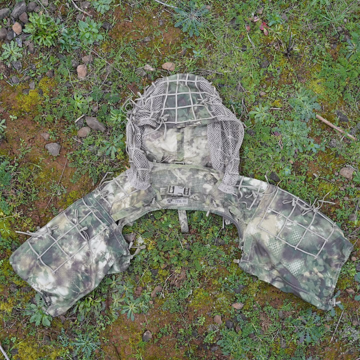 Enhanced Legacy Viper
The Enhanced Legacy Viper has been designed with Reconnaissance & Infantry troops in mind. This is a minimalist Concealment Hood, offering a lightweight & easily packable option for lowering the end-user's Visual & nIR Spectrum Signature.
+ Roll-Up Hood with webbing retainers allows for stowage of Hood; useful when the Viper is used in conjunction with our Legacy Recce Ghillie Helmet Cover.
+ Supports the use of upper chest mounted EUD devices via use of the Under the Vest or G Hook-to-MOLLE Adapters.
+ Designed to be worn in unison with chest rigs, plate carriers, waist-mounted gear, and backpacks.
+ Paracord Grid-Lattice + qty. 22 Veg-Tie-Cords w/Cord Locks attachment points to position and hold jute & natural foliage in place.
+ 57/43 NyCo Extreme IHWCU textile produced by Brookwood Rolled Goods exclusively for Sniper Dynamics.
+ Adjustable one-size-fits-most. A multitude of torso & hood tension cords to form a perfect fit with your custom gear loadout.
@tacticalconcealment @mmitextiles
@brookwoodcompanies @murdockwebbingcompany
