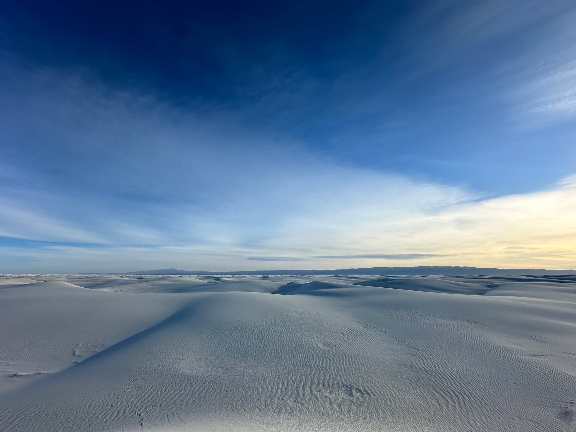 National Park 23 of 63: White Sands National Park.
For the longest time, Great Basin National Park held the place of my favorite national park. White Sands took the top spot. Maybe it was the extraterrestrial-like landscape or the vastness. Maybe it was the park’s place in my lineage. Maybe it was the solitude, the sunsets, the sunrises.
Welcome to White Sands National Park. An out of this world experience. White sand as far as you can see. Sinking toes as you climb dune after dune. A decades long hangout for teenagers in local towns. Seeking independence. An etch-a-sketch of little critter footprints.
If you have not made it here, do yourself a favor and plan the trip. You won’t regret it.