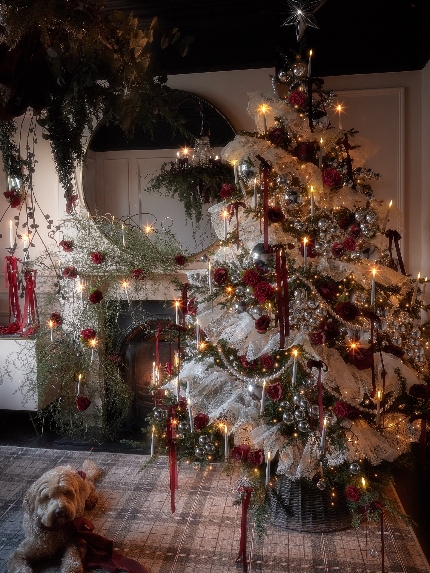 Finally, our tree of 2025 – meet our lacey Queen Highland Rose. 👑🌹❤️ Every Christmas we like to push ourselves a little further, and this year we went all in. Inspired by my daughter Bo’s coquette vision from last year, we wanted something with the same romantic spirit – but dialled up. So we supersized the lot. Same ingredients, just BIGGER. Proper maximalist energy.
As always, a lot of TLC went into it. And it turned into a crafty little project for me and my girl. Evenings spent threading oversized pearls into garlands and stiffening lace 🤪 (see last slide, but maybe that is a story for another post one day). We then wrapped the tree in hand-made ruffles we made from antique lace.
This year we have really embraced silver, with bundles of baubles in different sizes, including the odd giant sphere. We added deep red roses and tied long-tailed red velvet bows by hand. For years we have crowned the tree with a bow topper, but this season felt right for a classic star. Layered lighting again, mixing rose-gold twinkles with candle-style bulbs so we can turn the glow up or down depending on our mood.
The mantel stayed in the rose story. We created a rambling rose effect using delicate bundles of fresh thyme that trails from the shelf to the floor, with floating candle lights hovering in mid-air. Simple, but magical.
We finished the room with a gorgeous plaid rug from @ruggable_uk @ruggable #prproduct giving that traditional highland cosiness underfoot and tying into the rose accents.
And a special mention for Dusty the dog for always being the best tree and bow model. 🐕💝 We would love to know – would you lace or ruffle your tree?
Tree concept & styling by Nicki @andthentheywentwild and Bo aged 12
Christmas tree styling, Christmas decor ideas, festive home styling, Christmas inspiration, highland plaid interiors, seasonal decorating, creative interiors, home styling ideas. Lace tree styling, coquette Christmas tree, antique lace decorations, romantic Christmas looks, Maximalist tree design, oversized baubles, layered lighting, creative festive styling