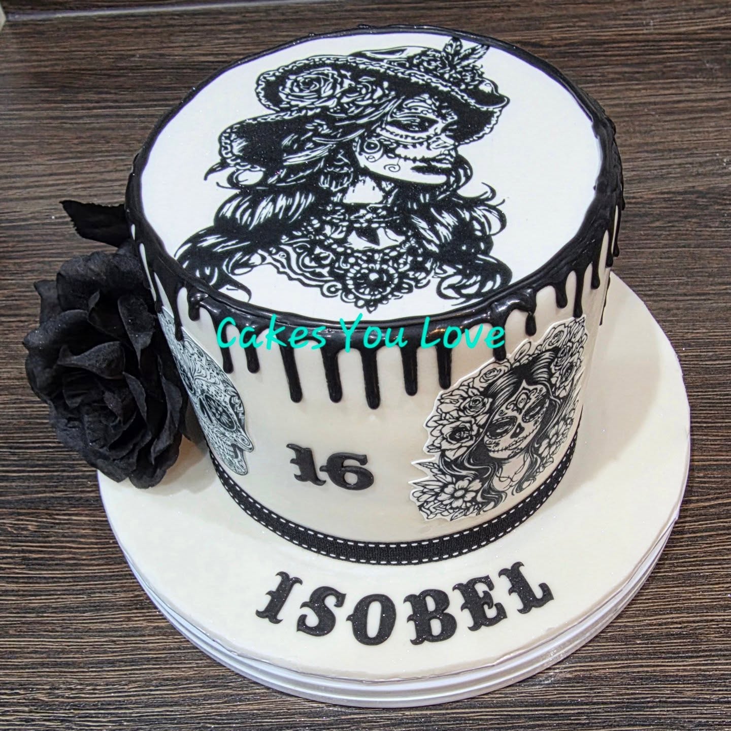 All images are printed with edible ink on to icing sheets. The drawing on top was drawn by the birthday girl herself. Finished with a black chocolate drip and silk flower
