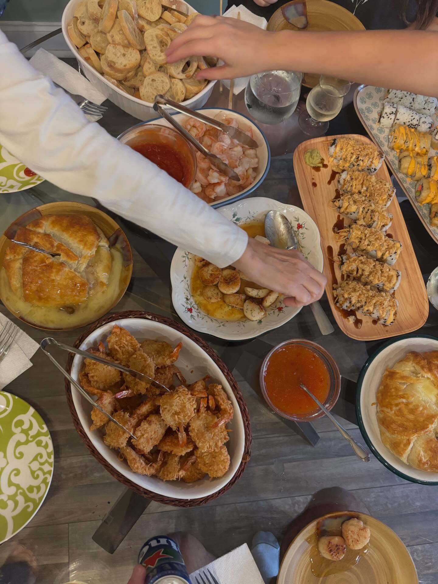 How we do Christmas Eve! Scallops, shrimp cocktail, coconut shrimp, puff pastry wrapped brie, and homemade sushi
