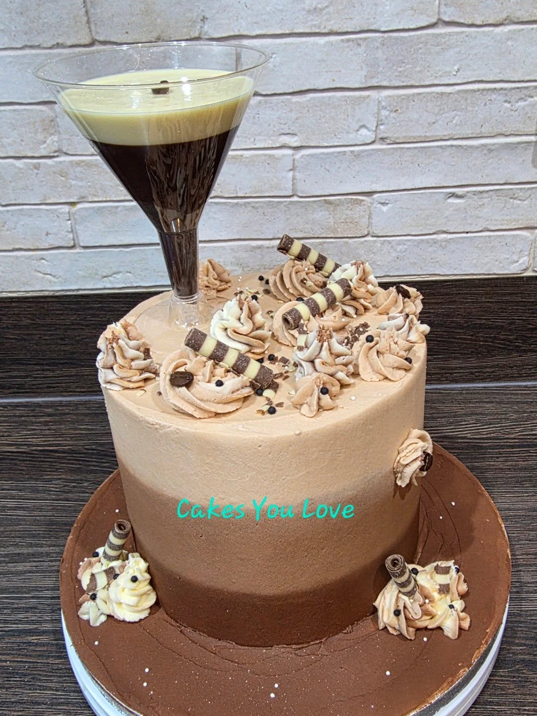 An espresso martini themed cake. The cocktail glass was filled with dark and white chocolate and a real coffee bean. A mini bottle of vodka was added by the customer
Inside was salted caramel filling.