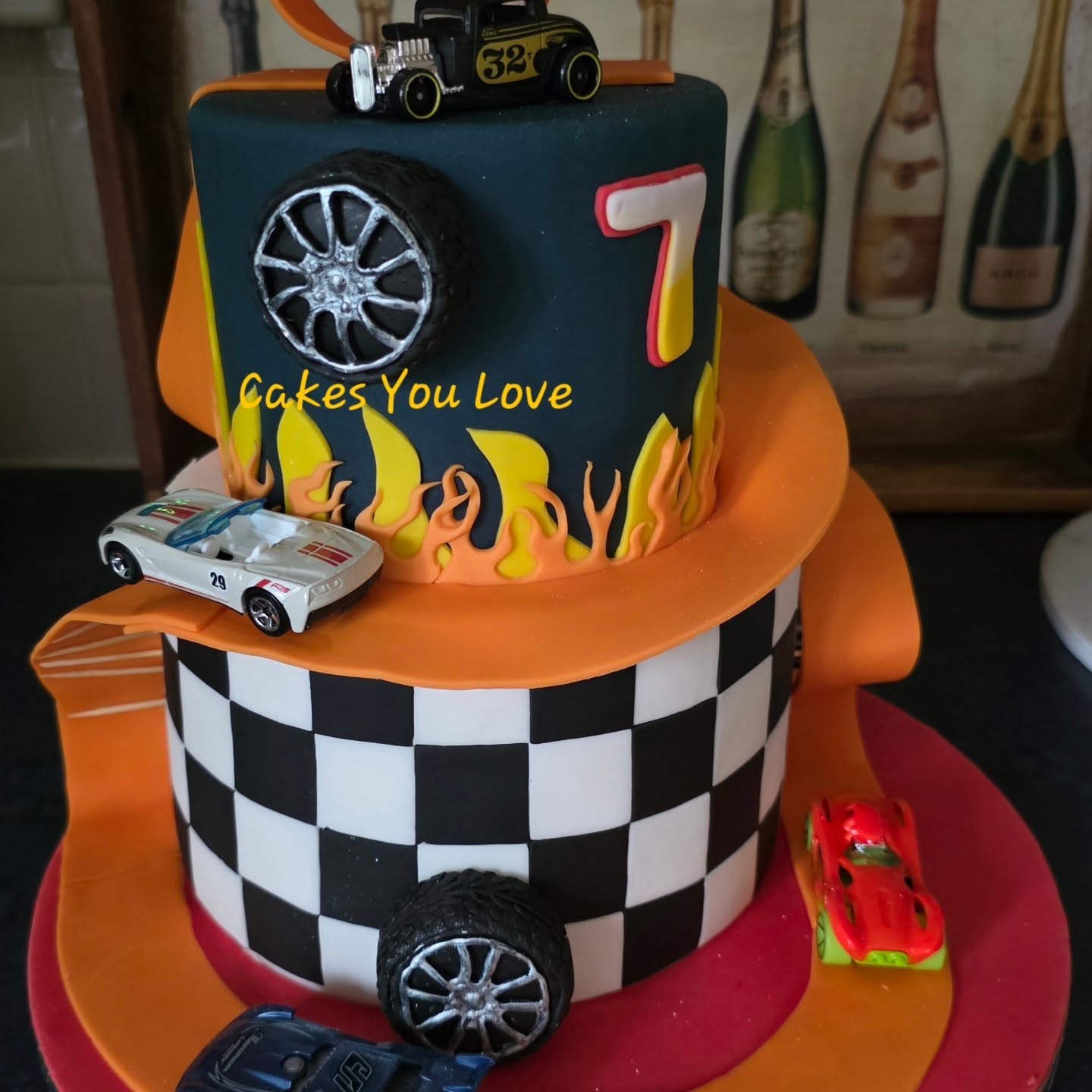 Had so much fun making this one. The top tier is a dummy cake but covered in fondant. The Hot Wheelz cars were a gift for the birthday boy. The track is fondant and so are the wheels.