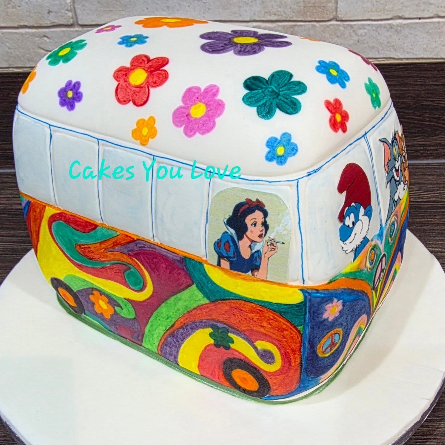 A quirky and fully bespoke campervan cake. I thoroughly enjoyed colouring this in and getting to play with the design. The requested characters are printed on edible icing and the colouring is edible pens