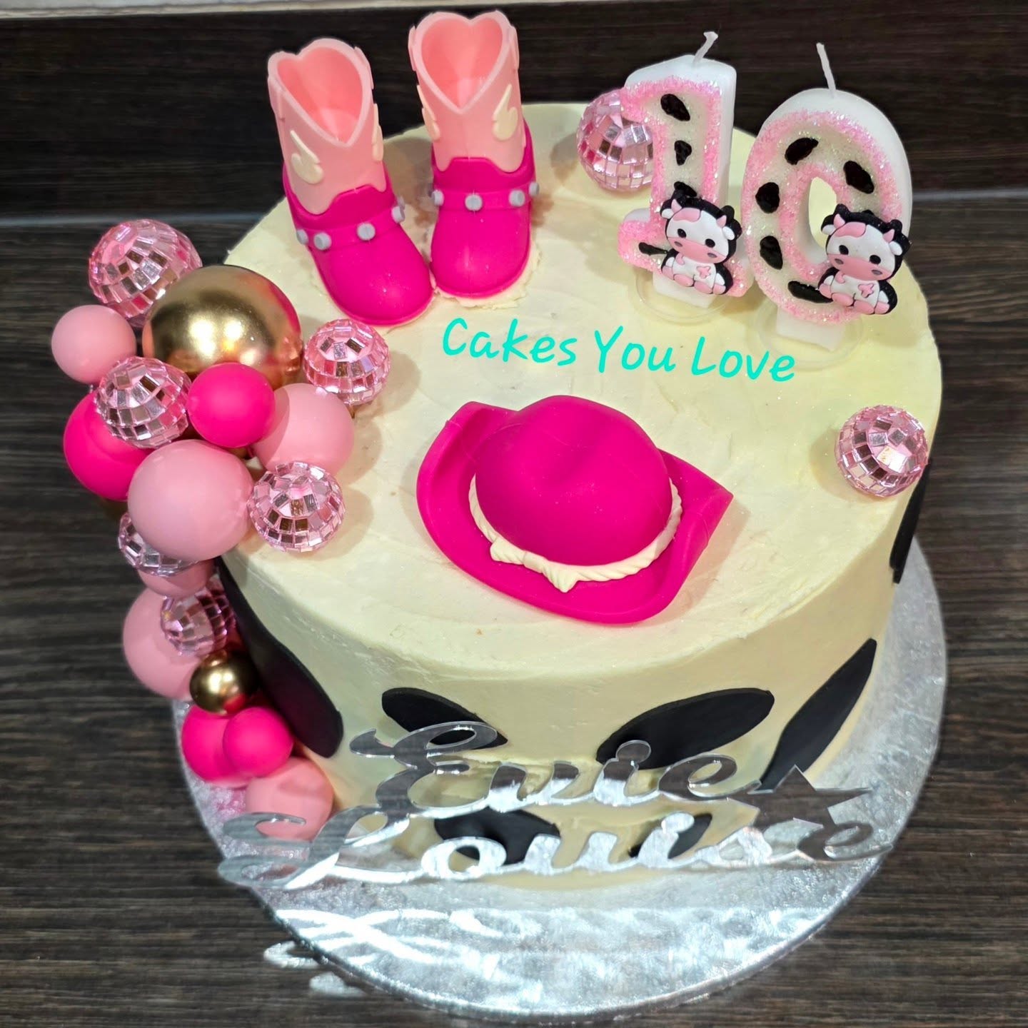 A cute little cowgirl themed birthday cake. All decorations are non edible. Check out those cute candles 🥰