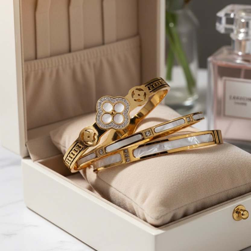 Set of three elegant stainless steel bracelets, water resistant, with white and gold marble patterns.